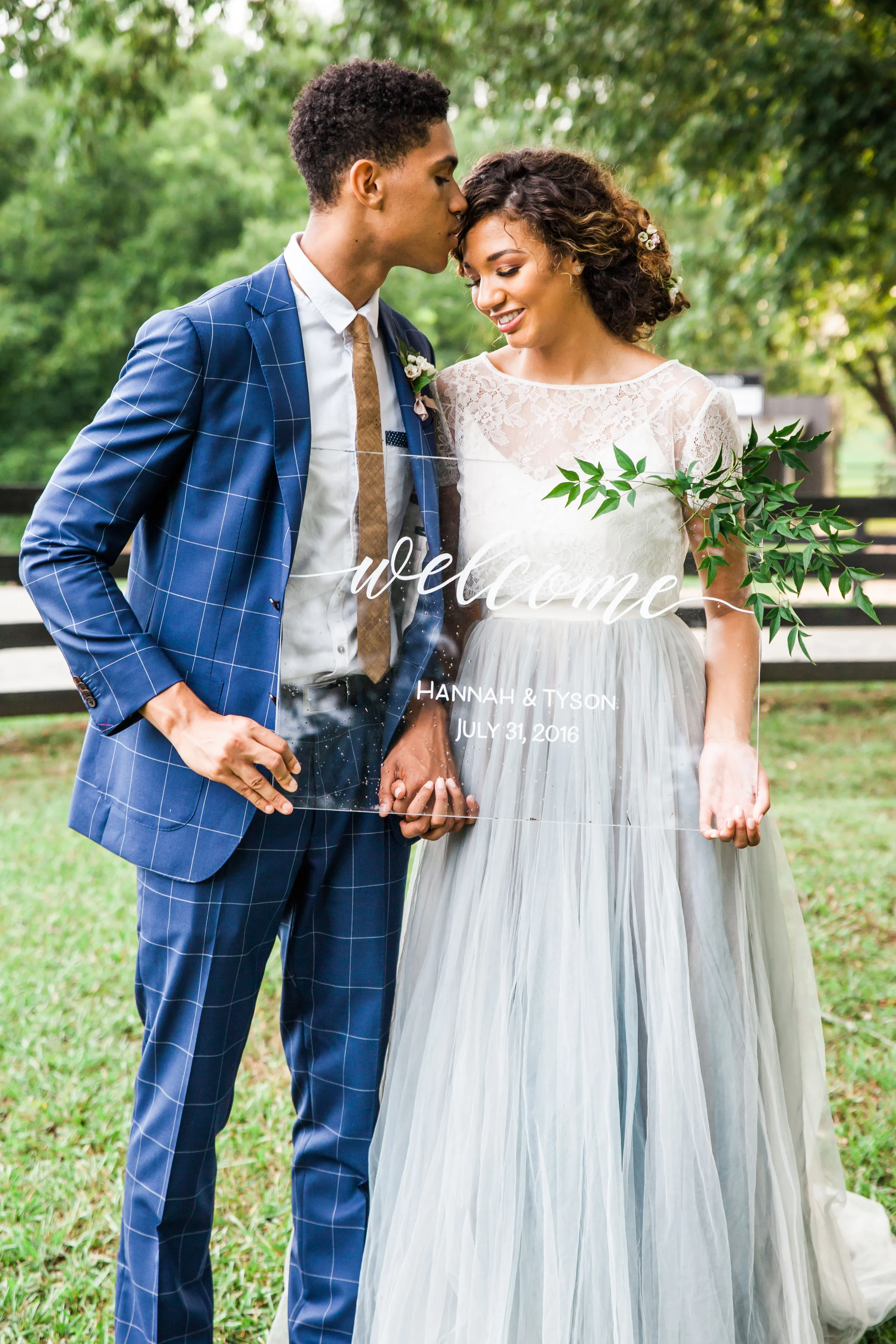 Greet your guests with a contemporary flair using a clear acrylic wedding welcome sign. This minimalist design relies on clean, fluid white script calligraphy to create an airy, upscale entry piece that perfectly complements a modern indoor reception