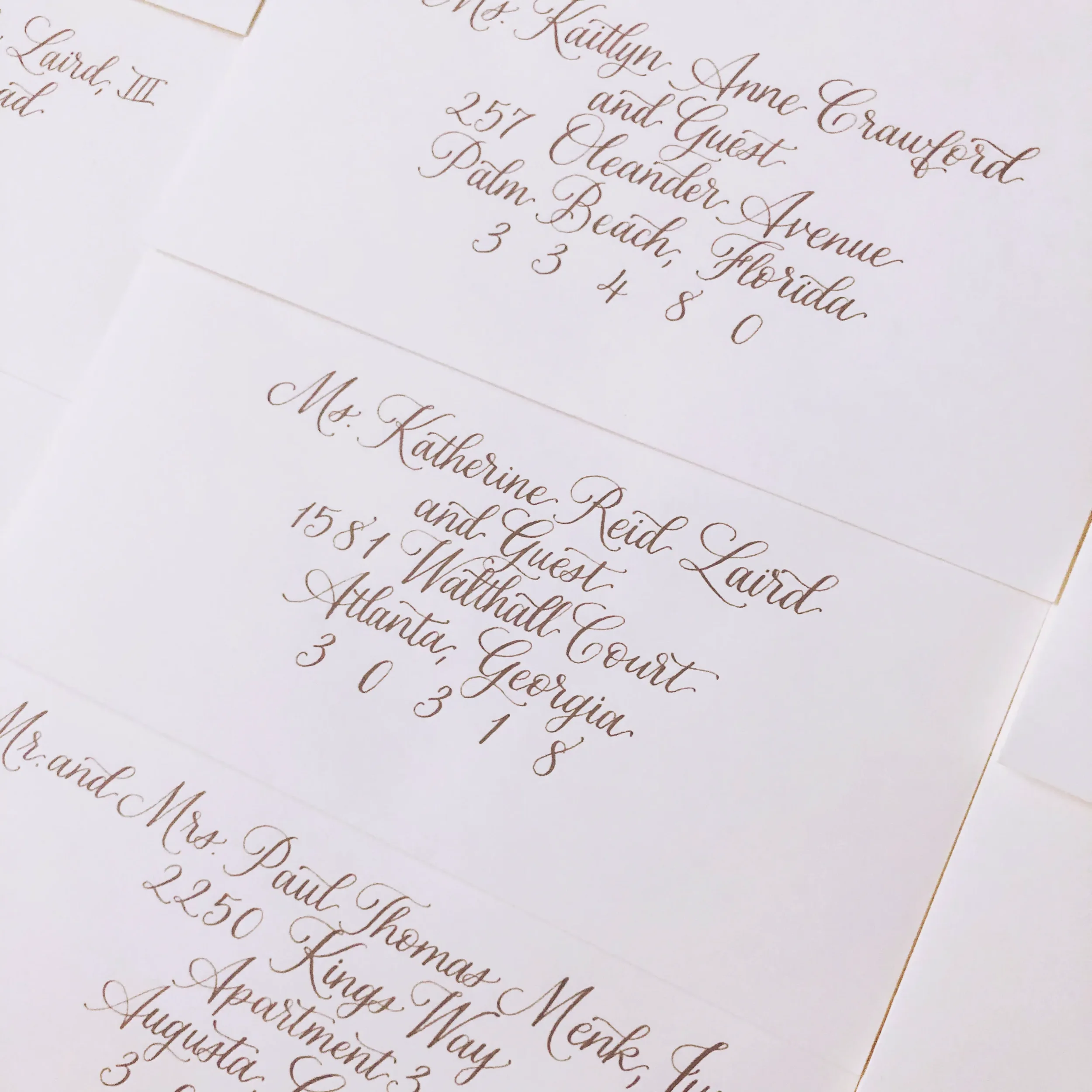 Stack of custom hand-lettered guest envelopes for an Atlanta, Georgia wedding celebration.