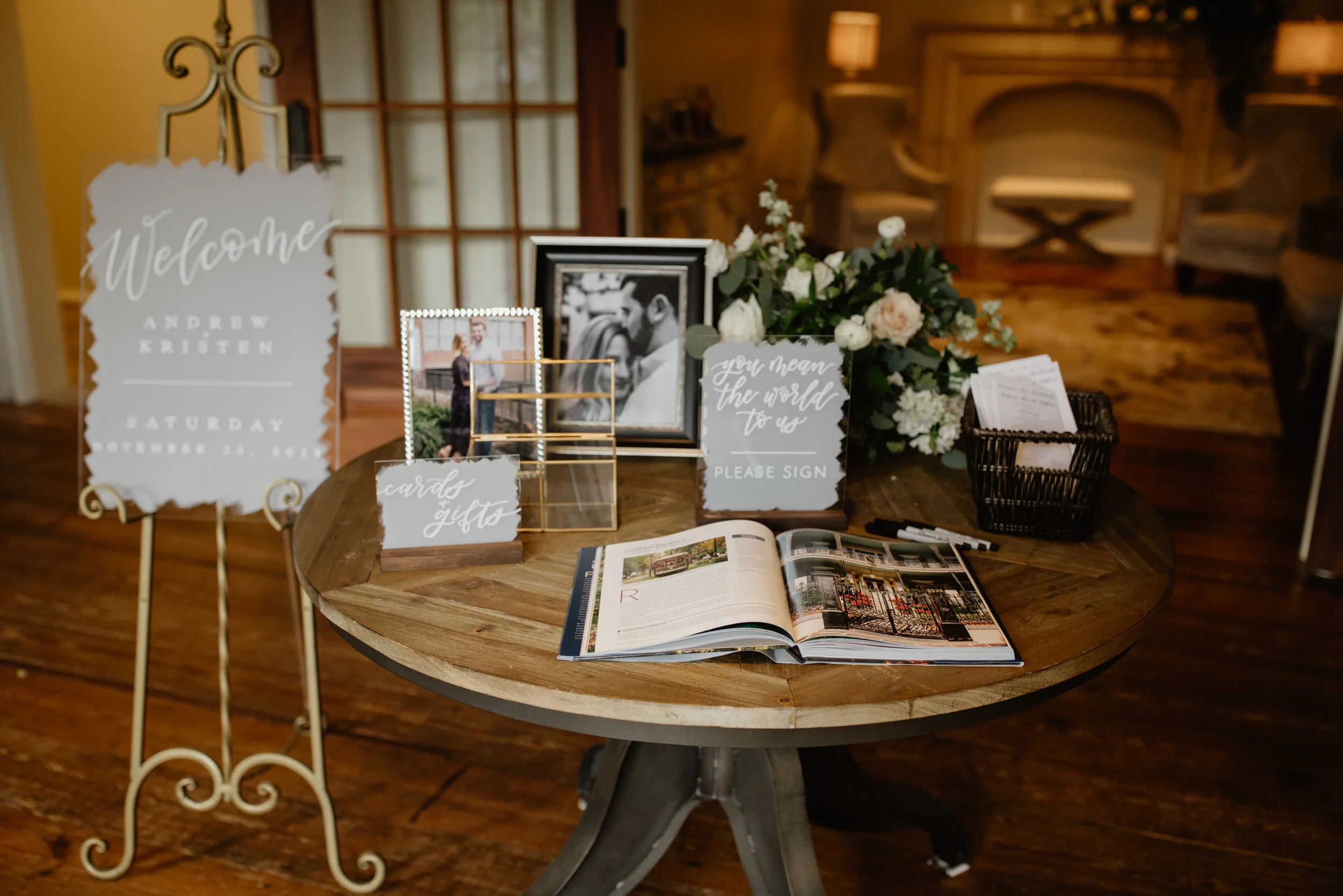 Make a stunning first impression at your venue with a painted back clear acrylic wedding welcome sign and guestbook sign. Featuring a custom painted-back brushstroke finish and elegant white script calligraphy, it stands gracefully on an ornate vinta