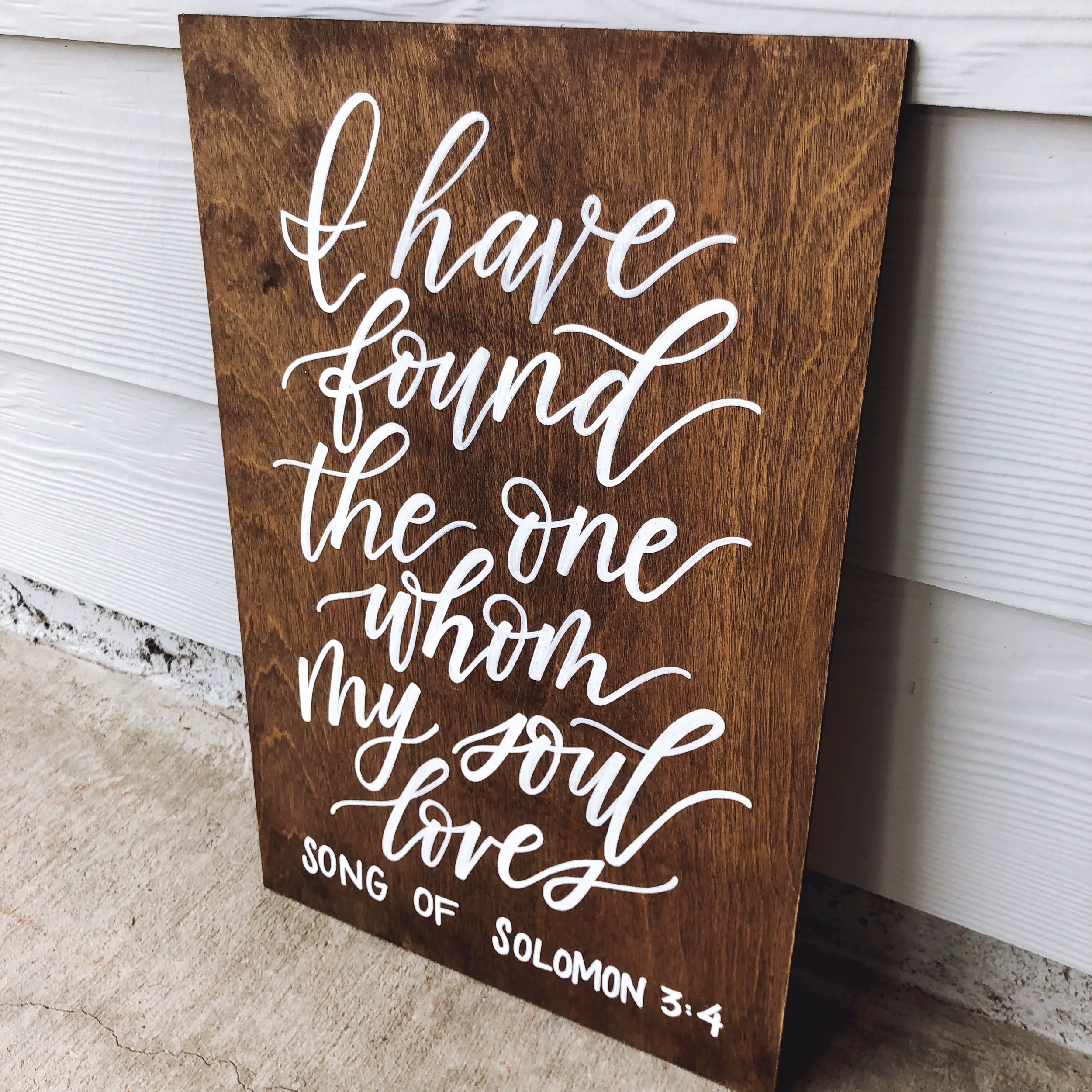 tained wooden sign hand-lettered in white script reading "I have found the one whom my soul loves" Song of Solomon 3:4.