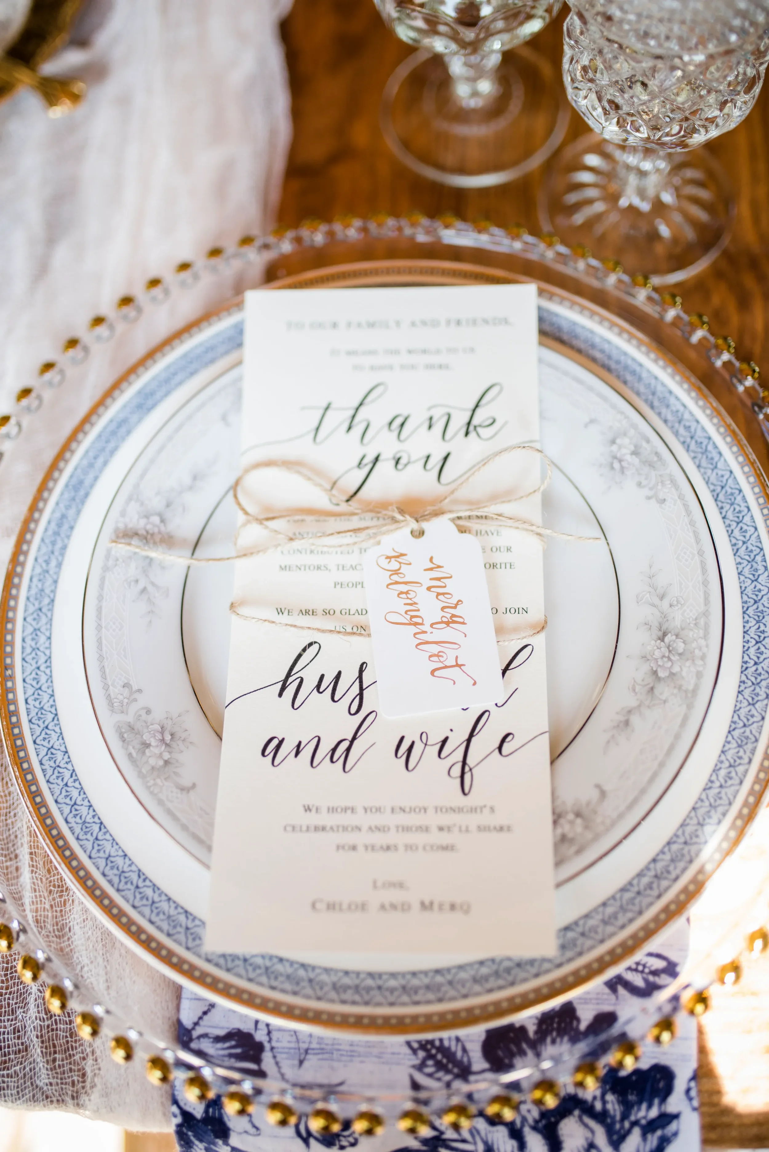 Ensure your wedding day paper goods seamlessly match your initial invitation suites. This elegant reception menu features beautifully structured calligraphy typography, acts as a heartfelt thank-you card to guests, and is delicately tied with rustic 