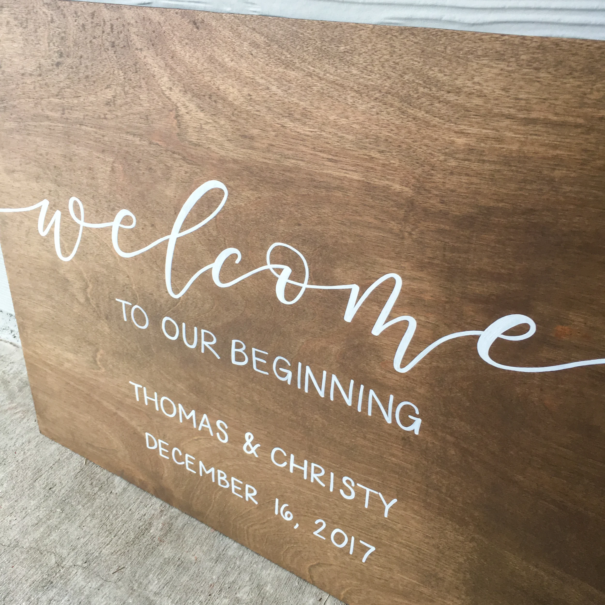 Stained wood wedding welcome sign for rustic outdoor wedding.