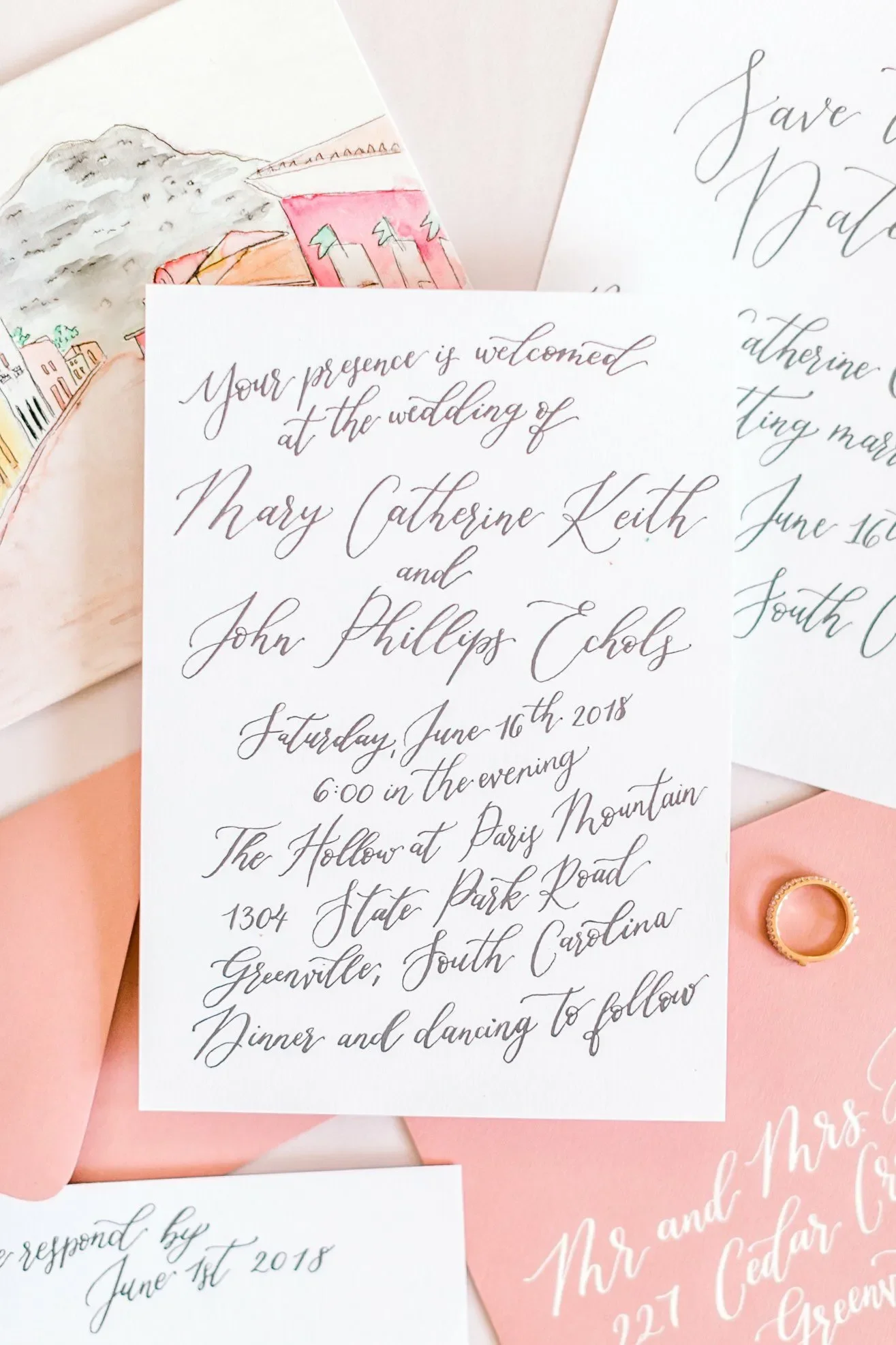 Infuse personalized, artistic storytelling into your big day with a coral pink watercolor invitation suite. Highlighting a custom hand-painted illustration of the wedding venue, this colorful stationery set pairs soft peach envelopes with modern call