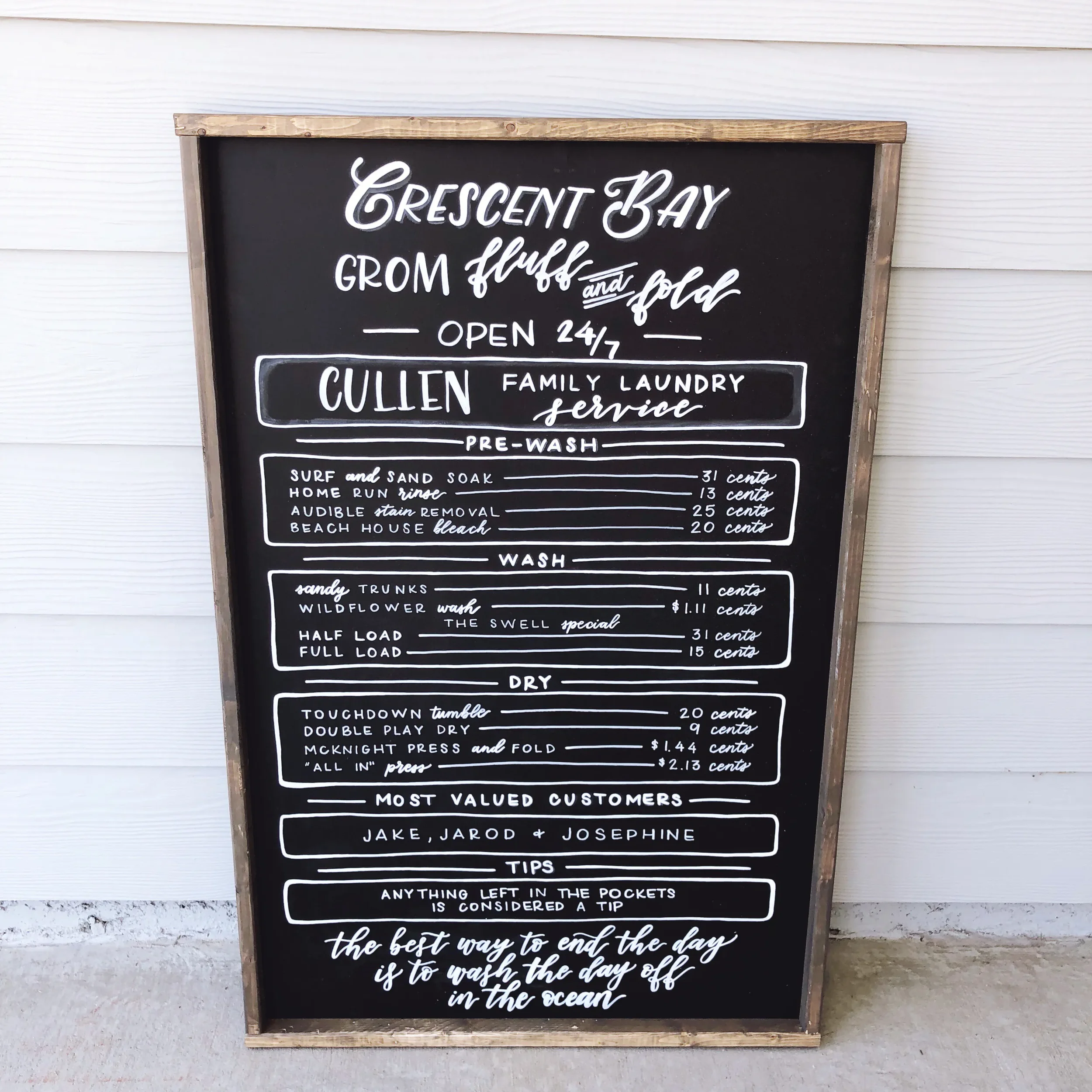 Custom wooden framed chalkboard for laundry room displaying a customized laundry service menu and pricing guide.