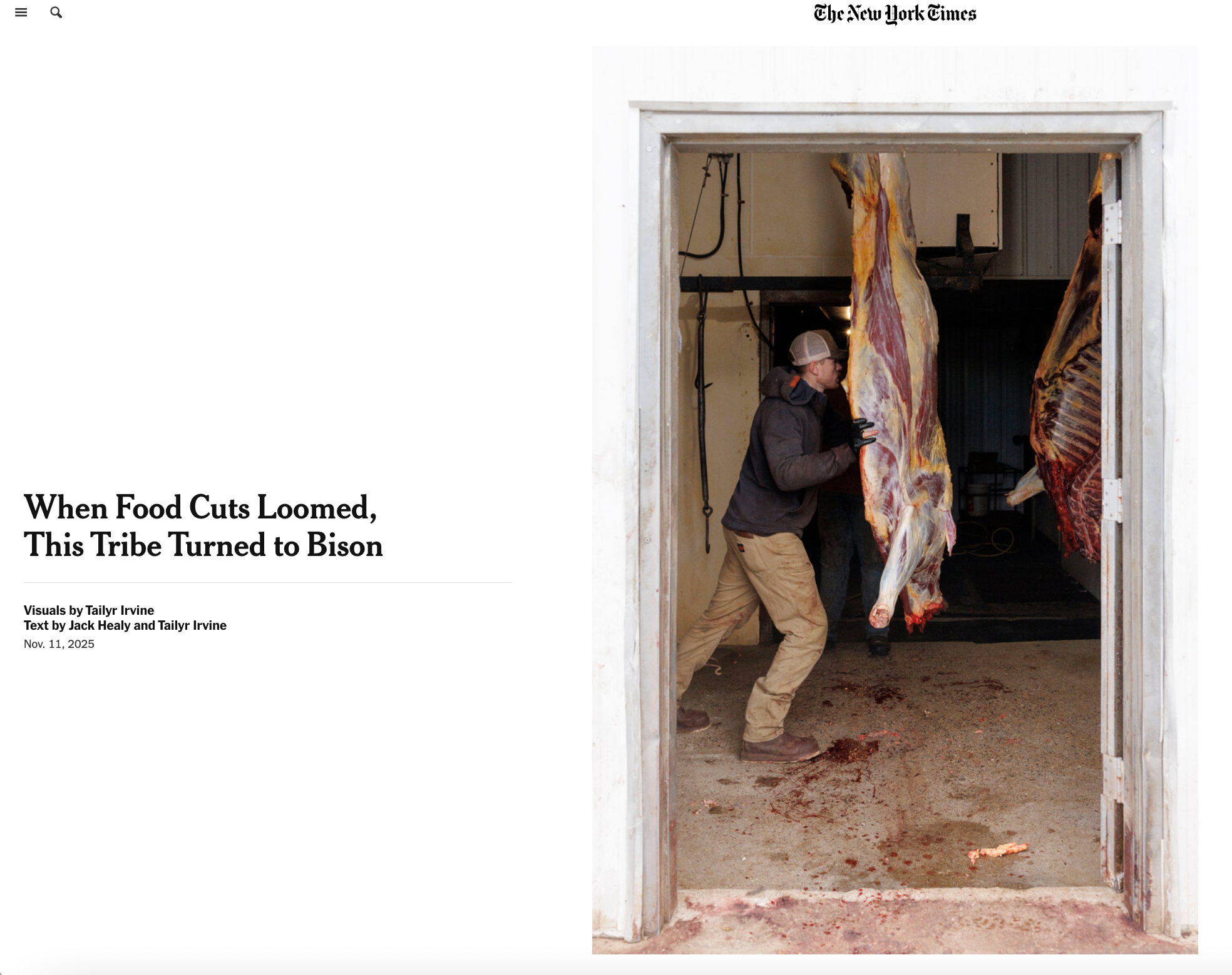 Man wearing a cap and gloves working inside a butchering room, handling a large hanging slab of meat, with blood on the floor.