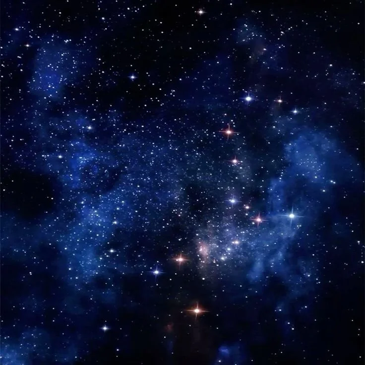 A view of outer space showing numerous stars and galaxies against a dark sky.