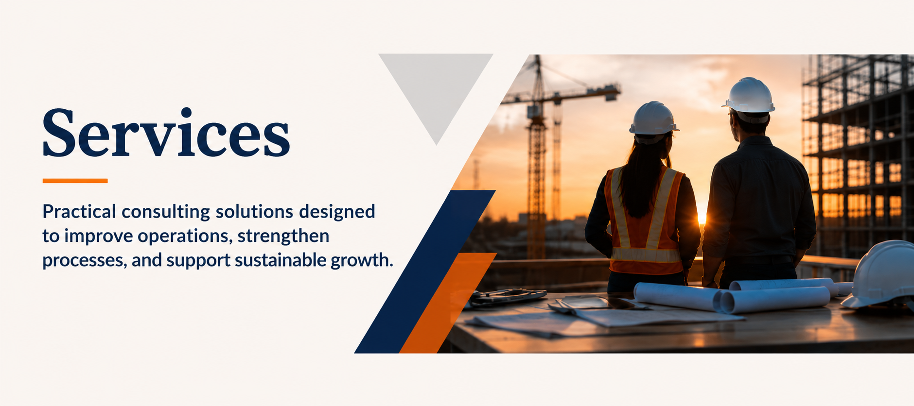 Two construction workers, a woman and a man, in safety helmets and vests, standing on a building site during sunset, overlooking construction cranes and framework with construction plans on a table in front of them.