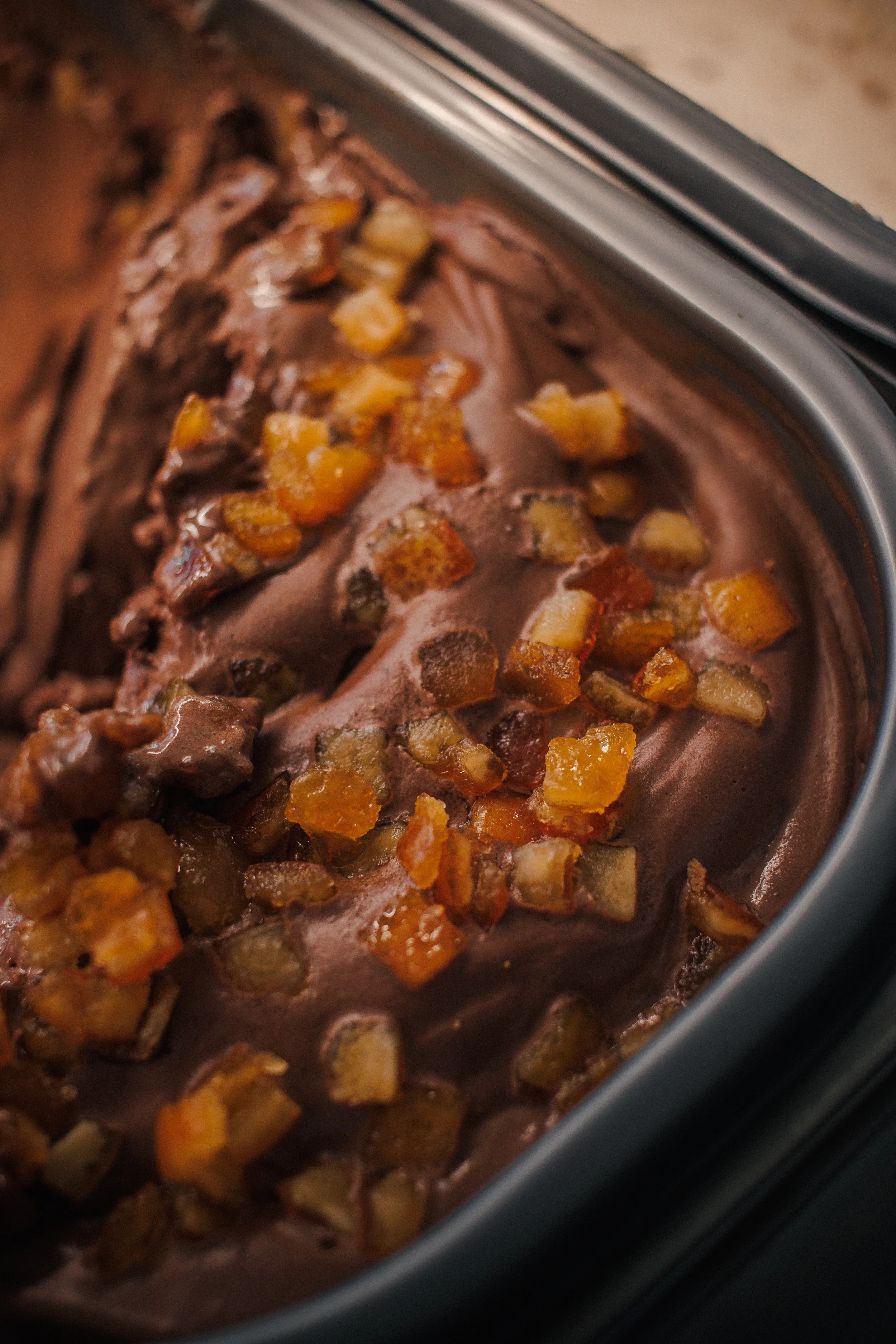 Close-up of a slow cooker filled with diced potatoes and beef in a brown gravy.