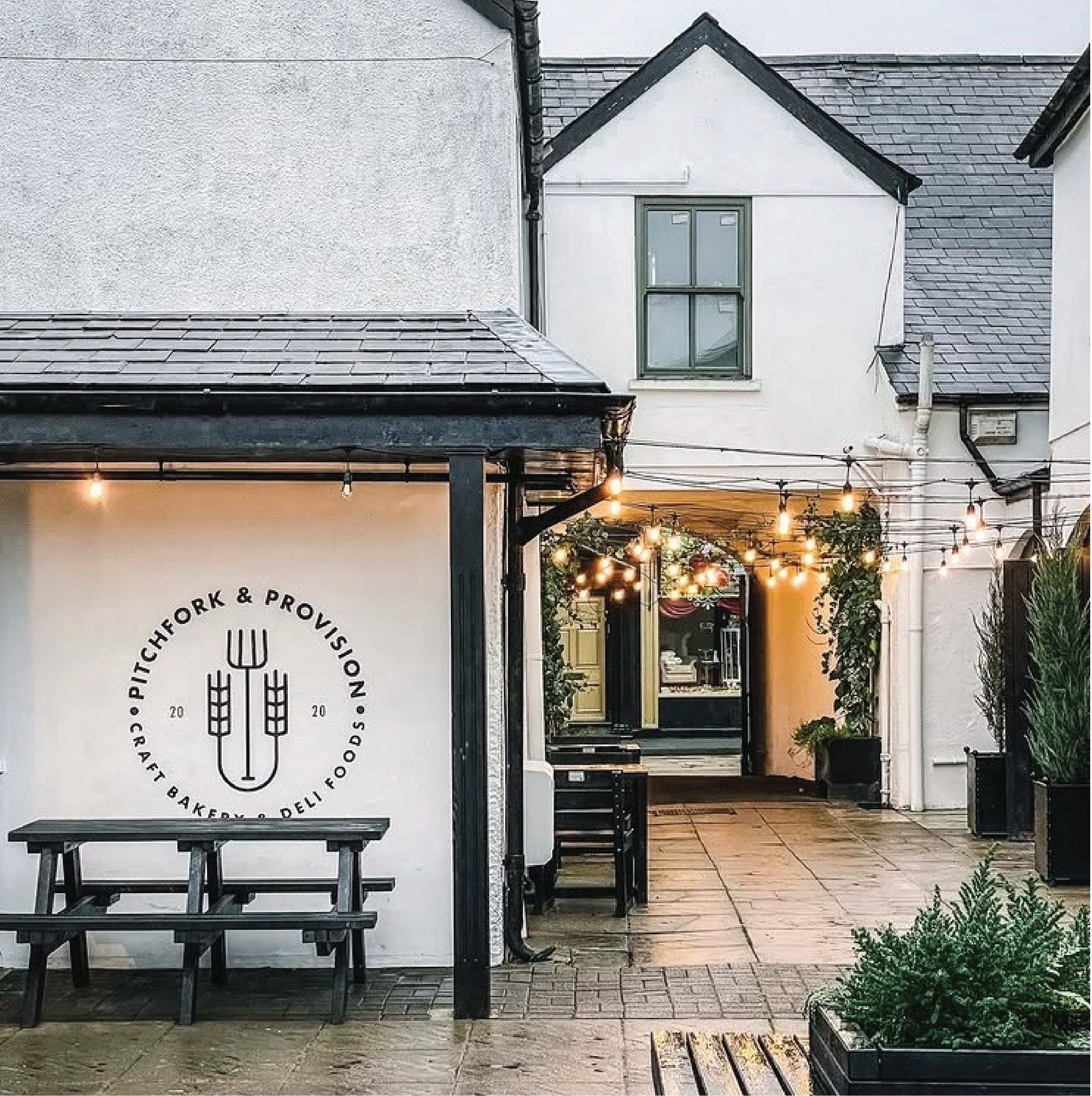 Brand identity design for craft bakery business Pitchfork & Provision. Logo on display in courtyard.