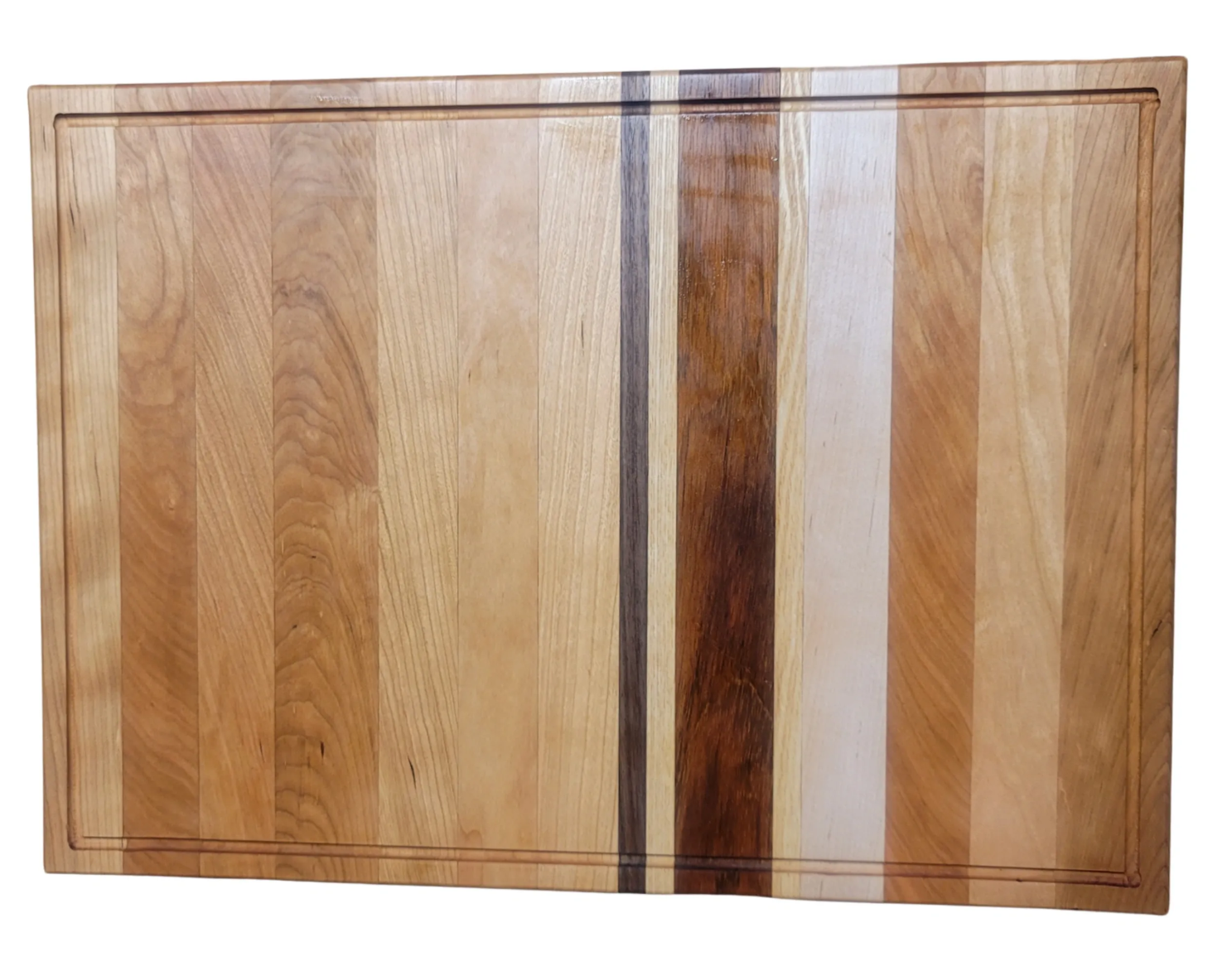 A rectangular wooden cutting board with a striped pattern of various wood tones and a carved border.
