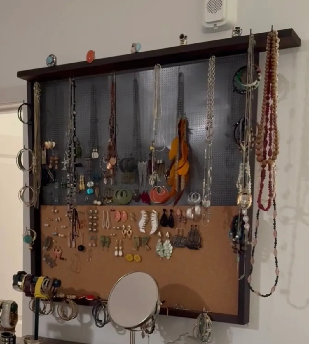 Jewelry display board with necklaces, earrings, and rings