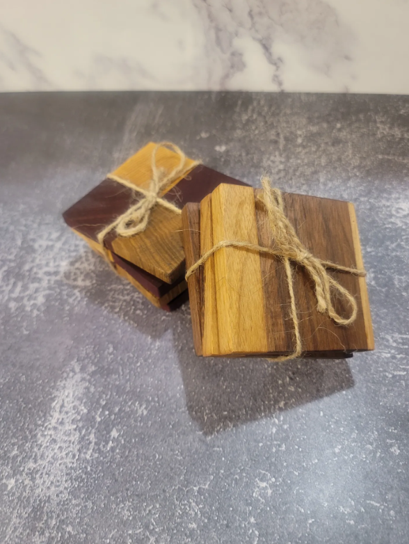 Two bundles of wooden pieces tied with twine on a gray surface.