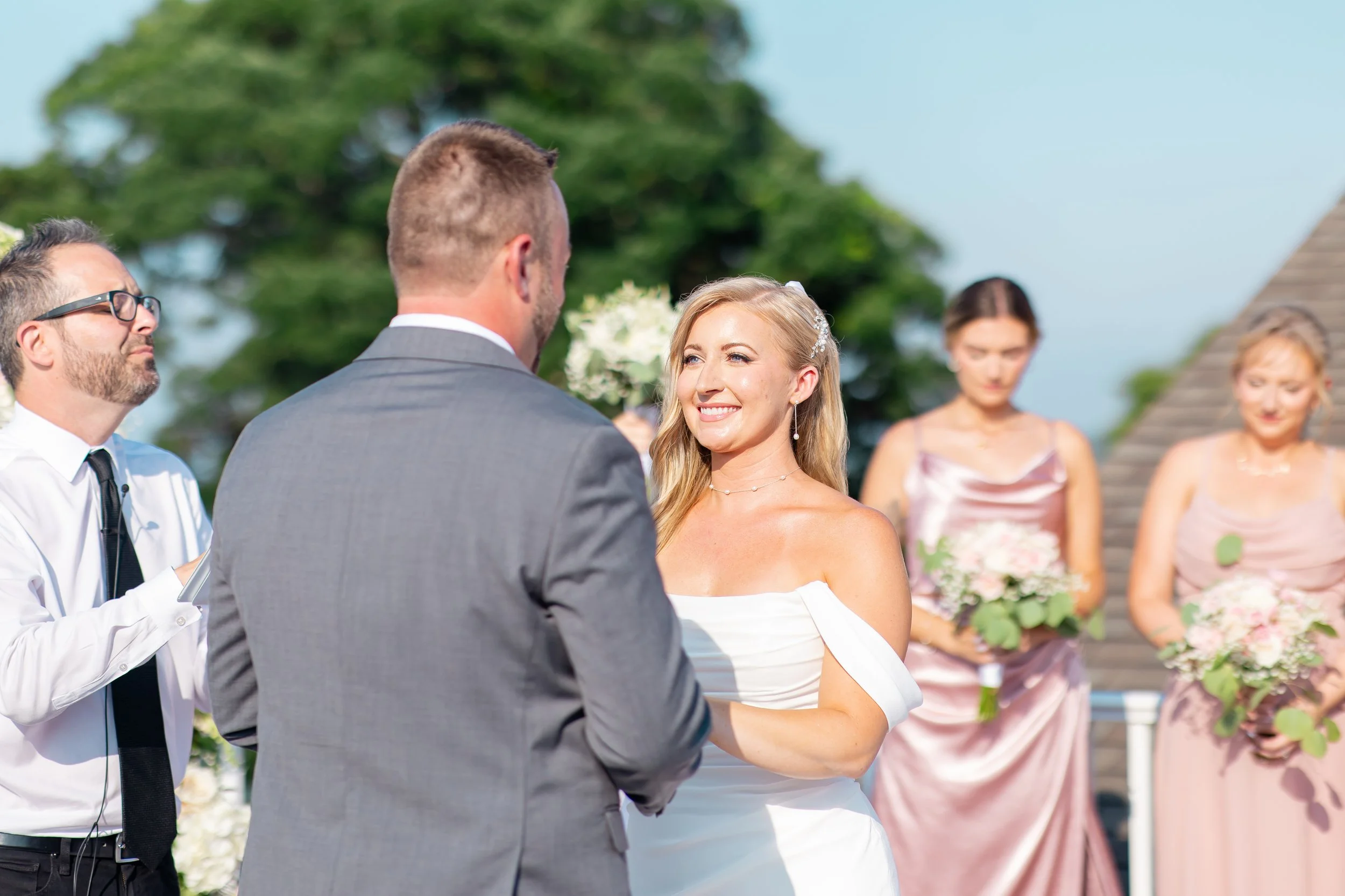 Professional makeup artist creating timeless beauty for a luxury waterfront wedding.