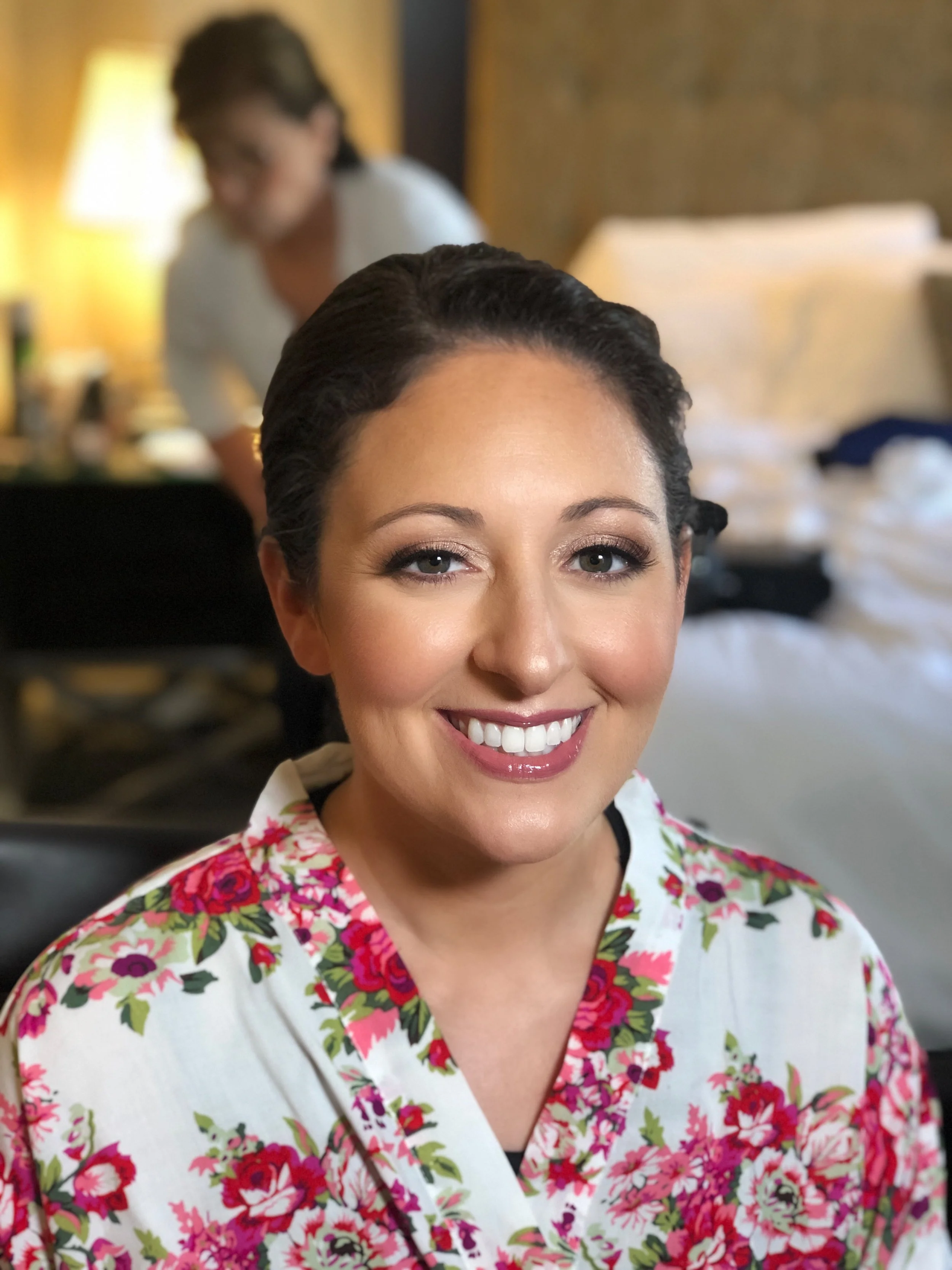 Wedding morning beauty preparation with professional bridal makeup artist.
