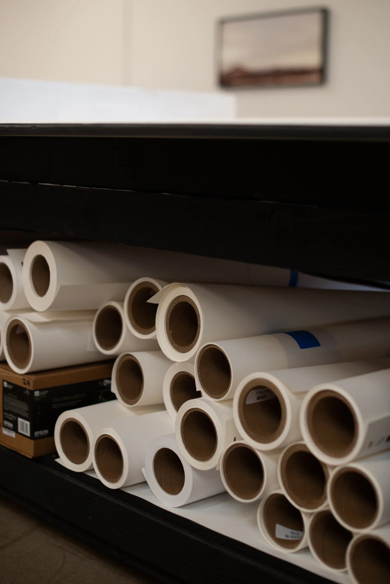 Stacks of rolled printer paper and canvas at General Public.