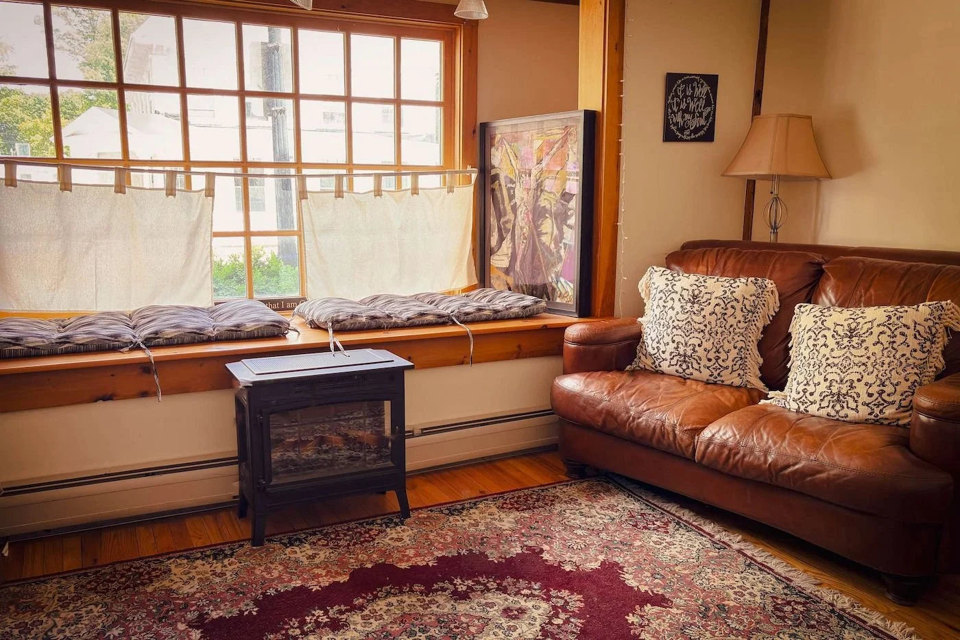 The Prayer Room interior at The Living Room, Henniker NH, with a leather couch and area rug
