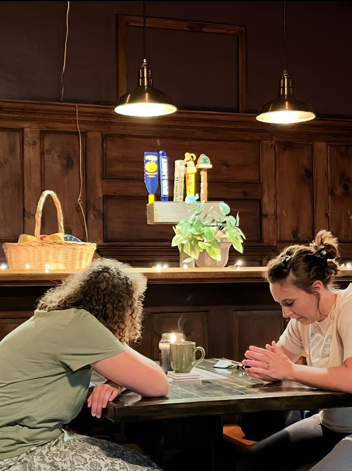 Two people praying together during a spiritual counseling session at The Living Room