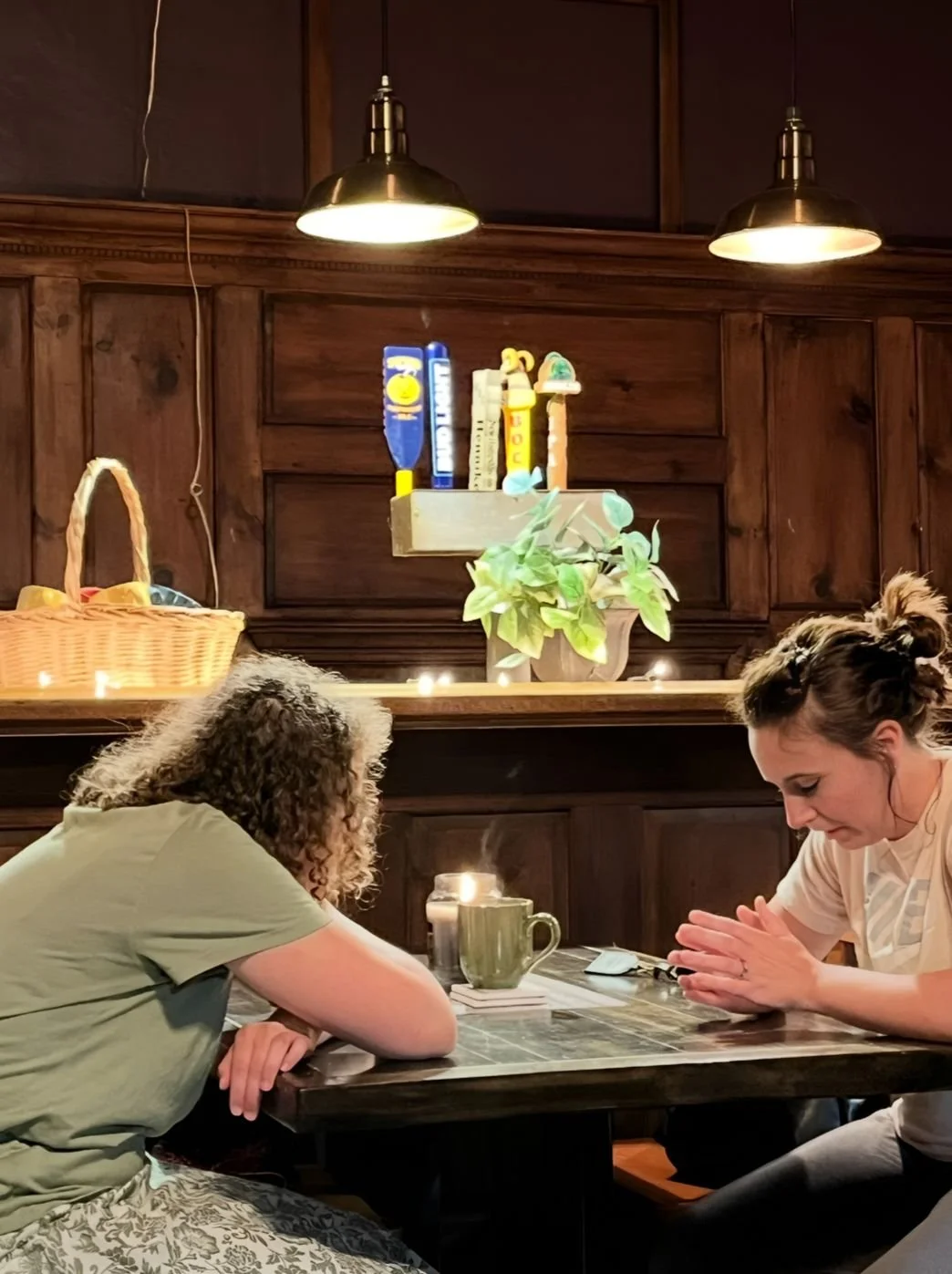 Noelle Jones praying with someone at a table
