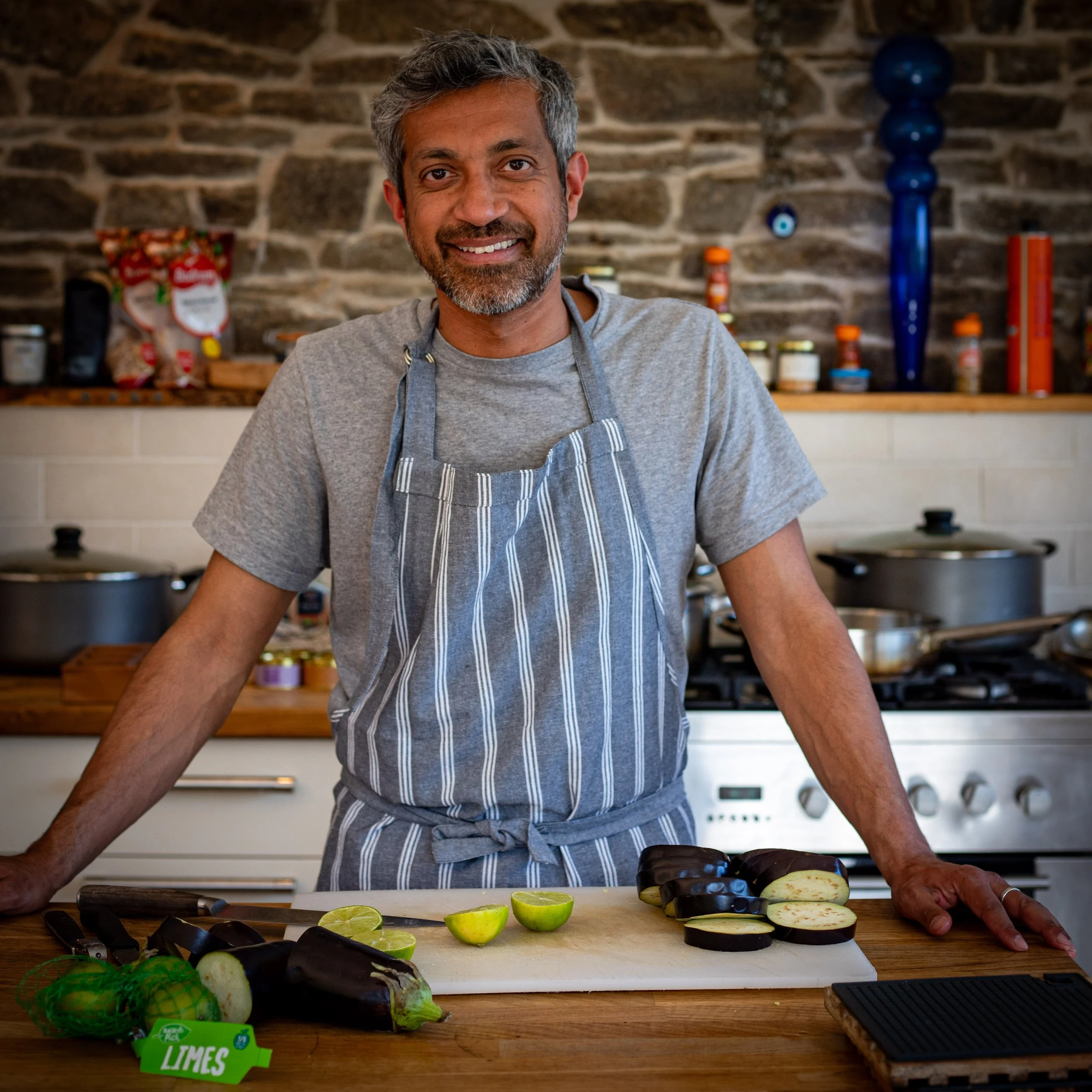 Sid, founder of Little Rasoi, in the kitchen cooking delicious Indian food at a yoga retreat event.
