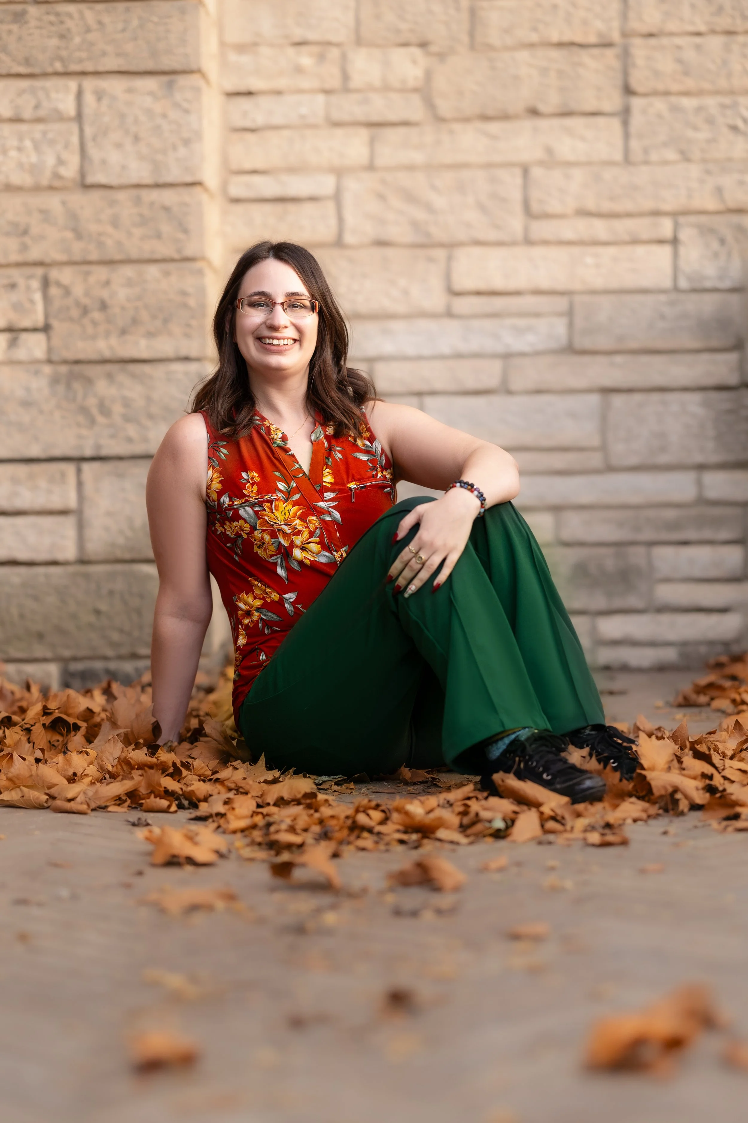 A female substance use therapist in Nova Scotia sitting outside wearing a floral shirt