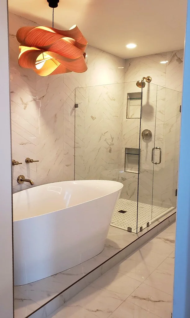 Modern bathroom with a free-standing bathtub and a glass-enclosed shower.