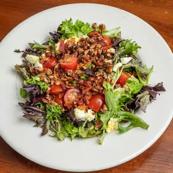 Mixed salad with chopped greens, cherry tomatoes, and seasoned ground beef on top