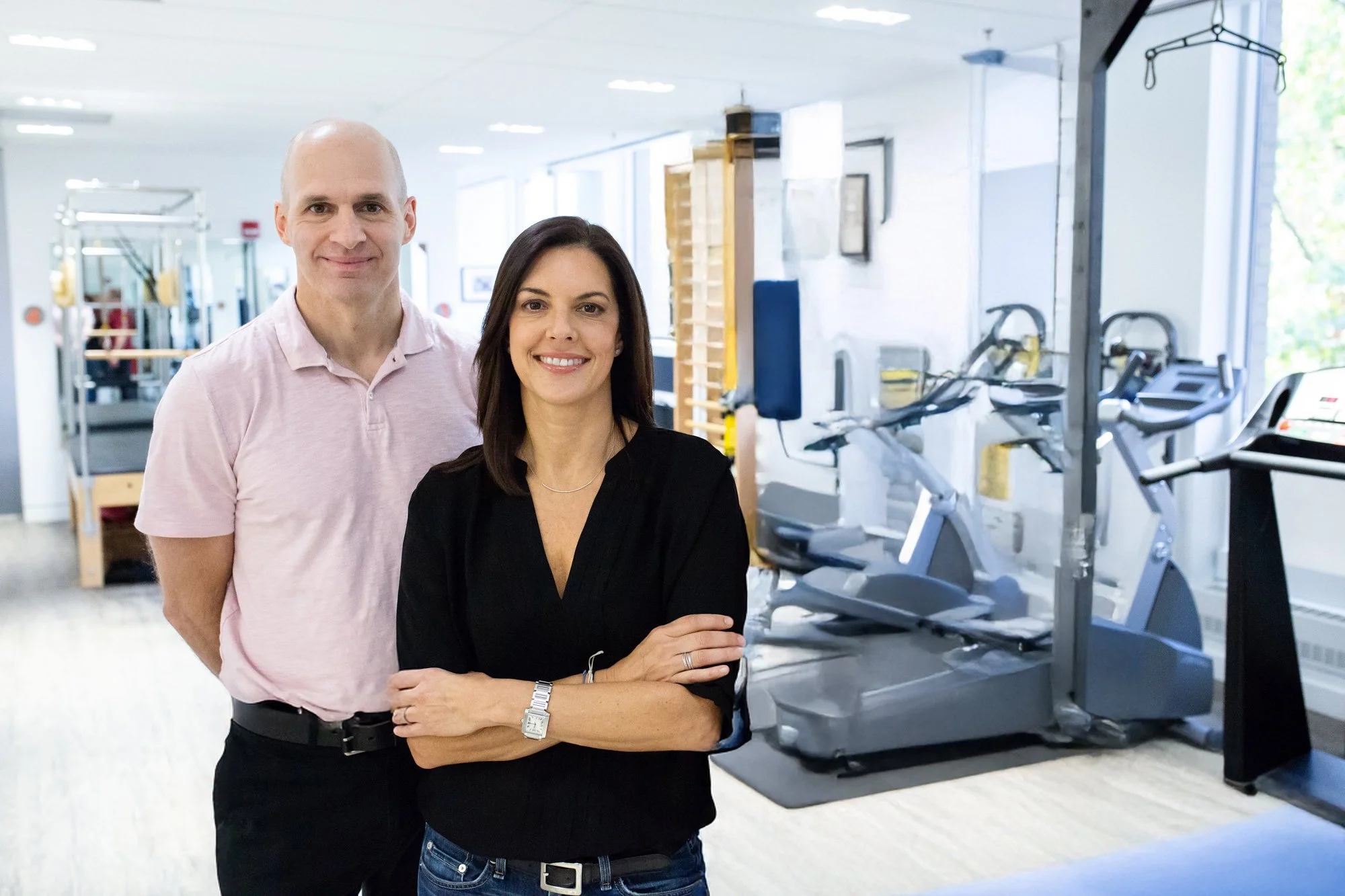 Hilary Granat and Jeff Robinson, physical therapists, smiling at camera