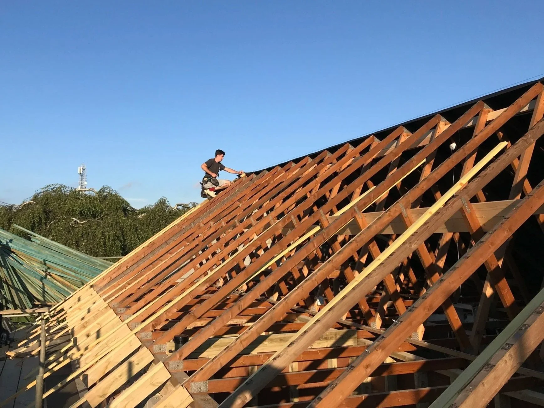 Elmwood Carpentry And Construction - Wooden Roof Being Worked On By A Man