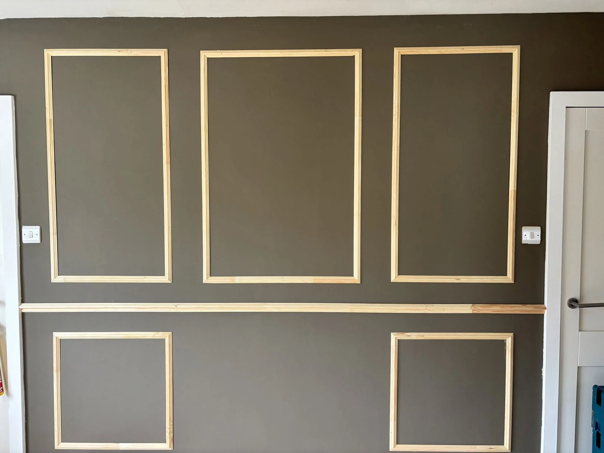 Interior wall with five wood panells.