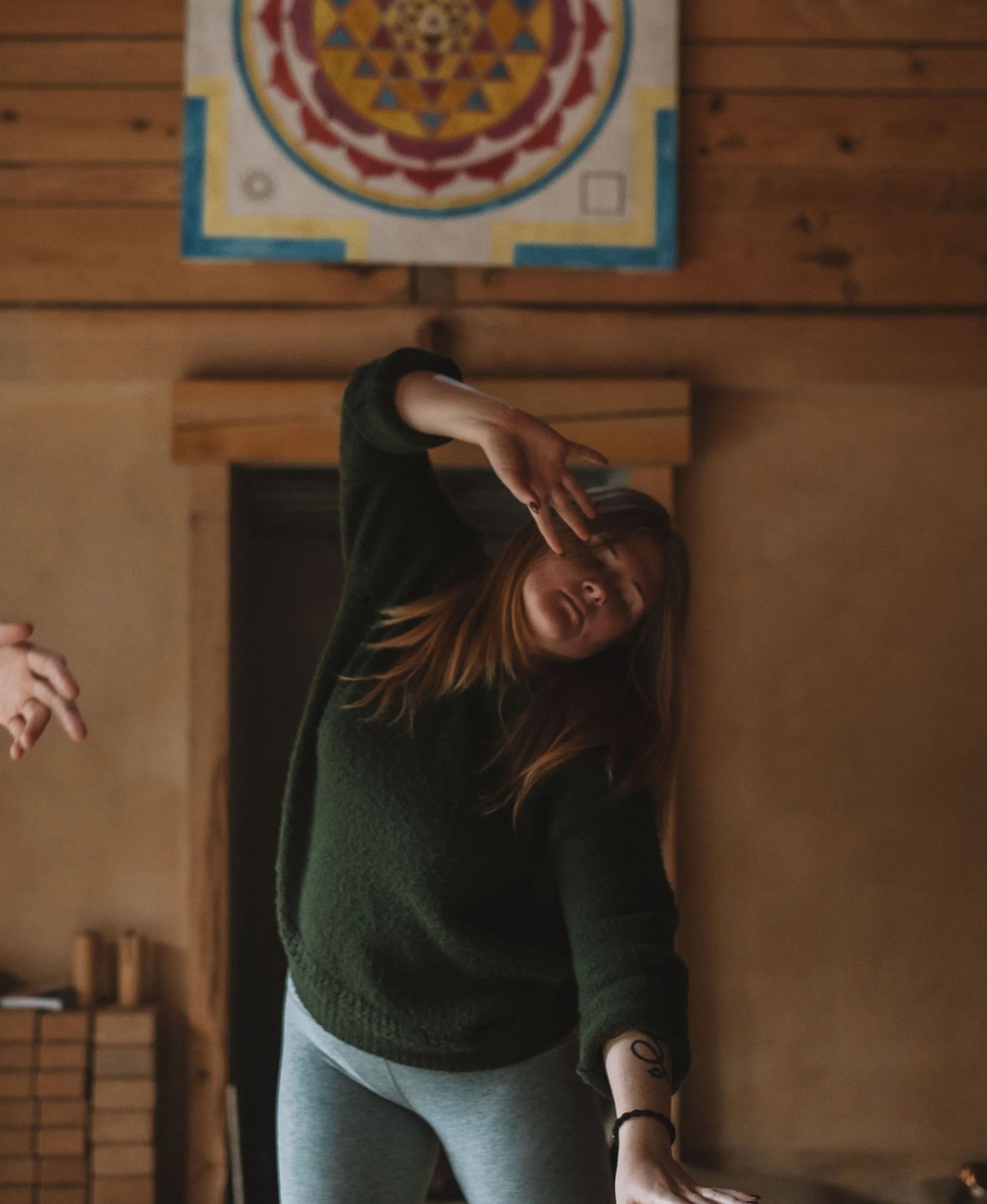 A woman engaging in embodied movement during a retreat.
