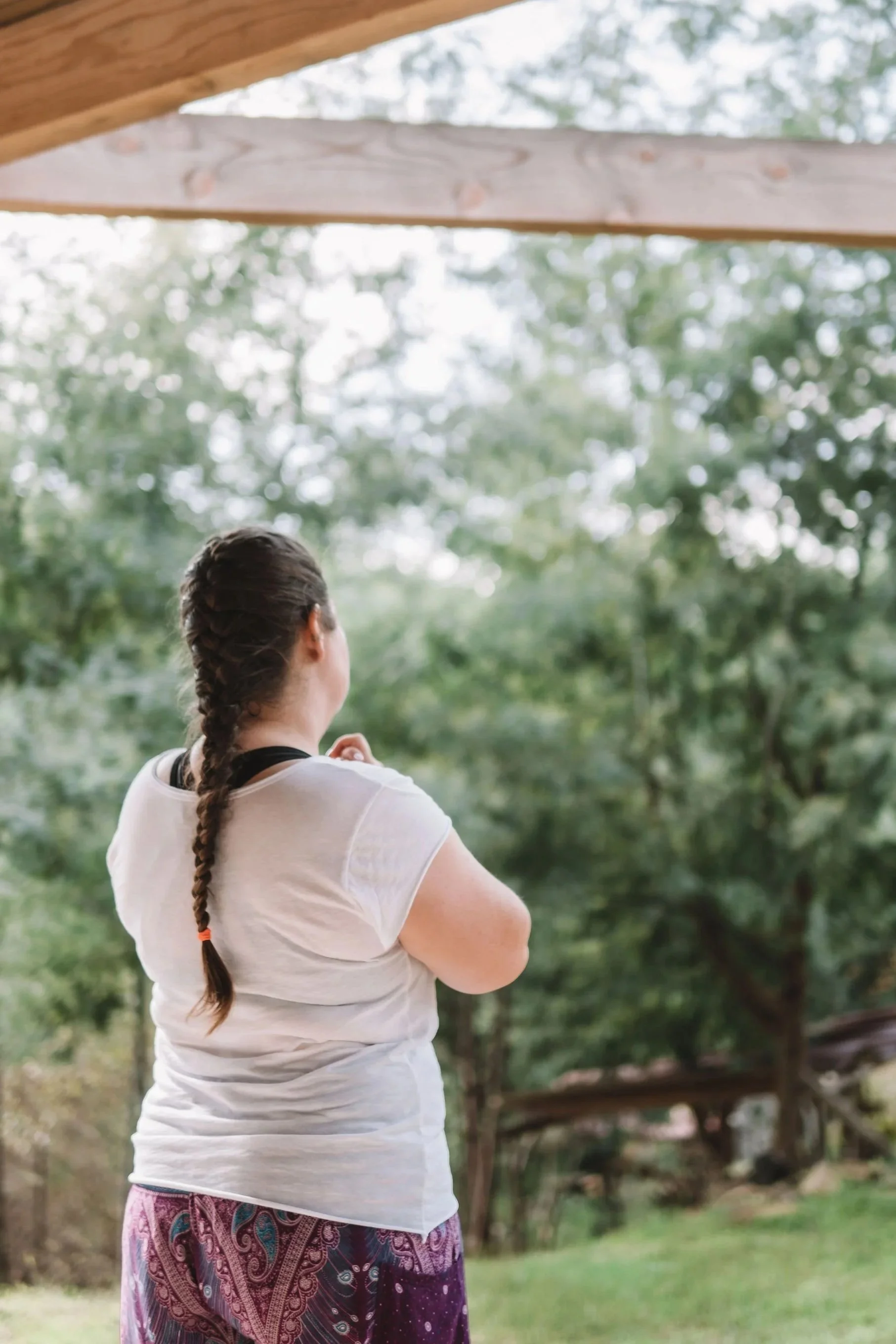 Woman on retreat reflecting in nature.