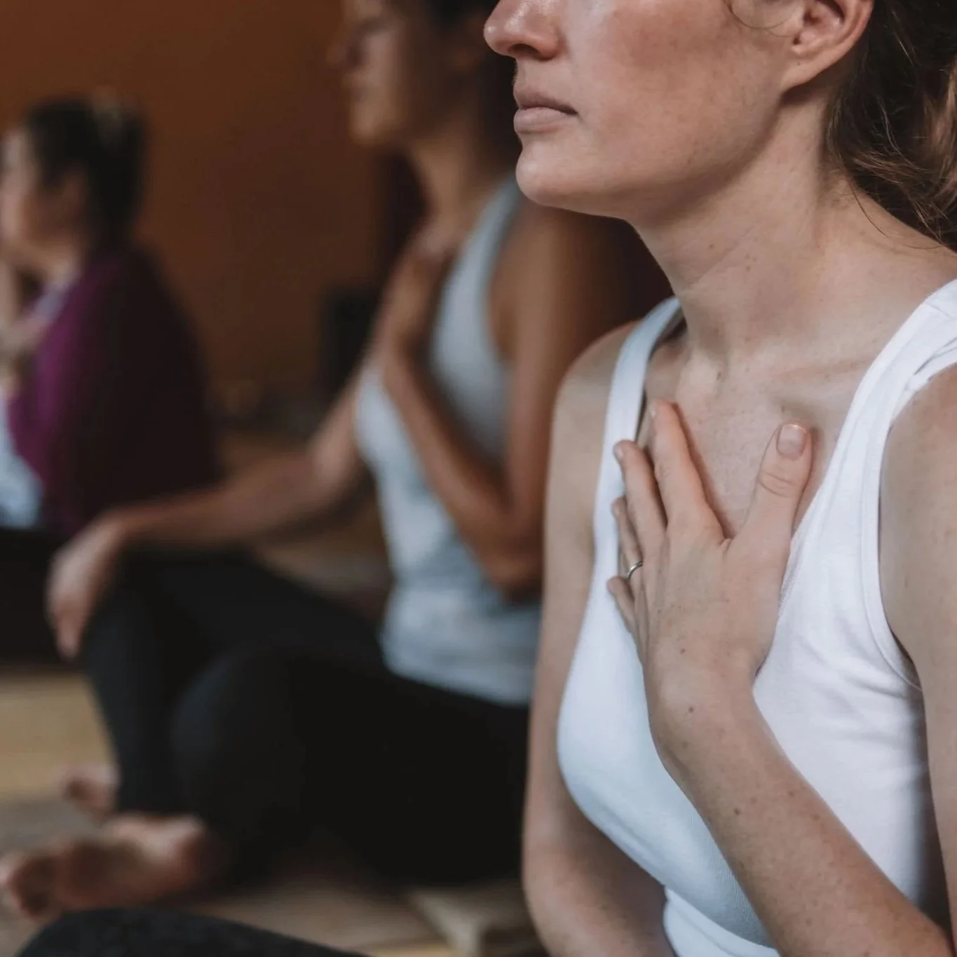 Women on retreat participating in a grounding meditation.