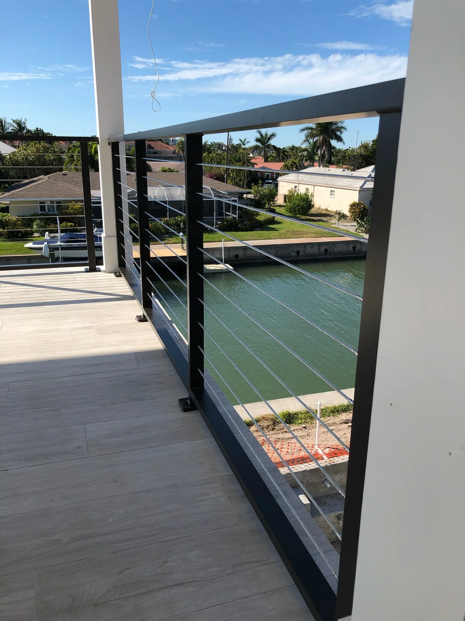 Custom railings Sarasota waterfront balcony installation by APG Welding.