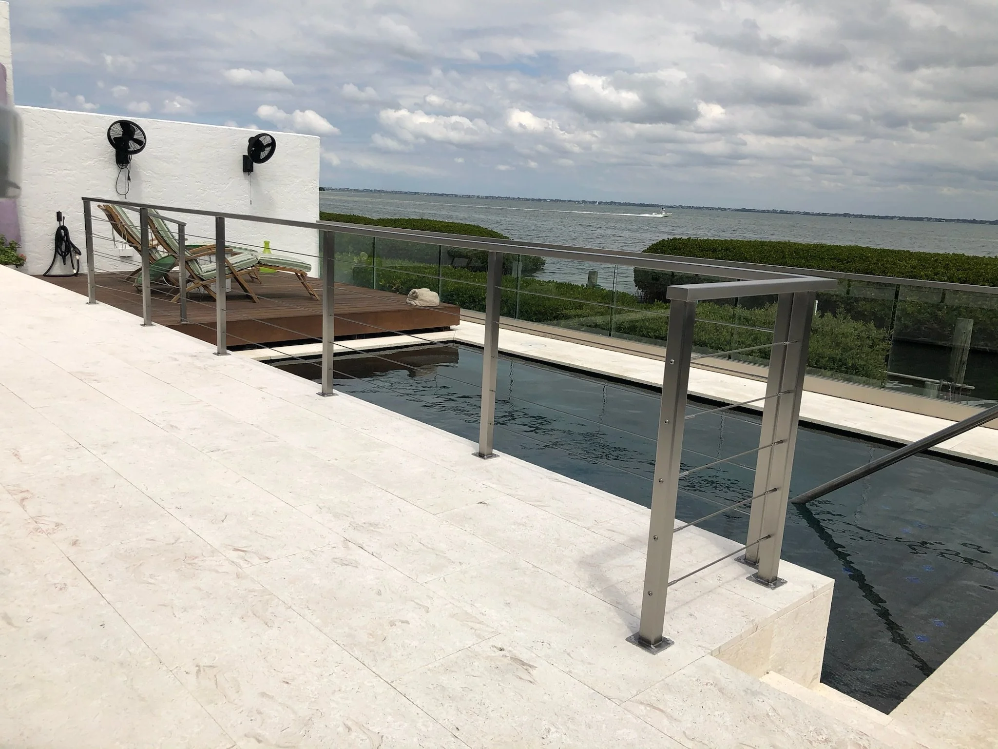 Modern glass railings Sarasota waterfront balcony with unobstructed water views.