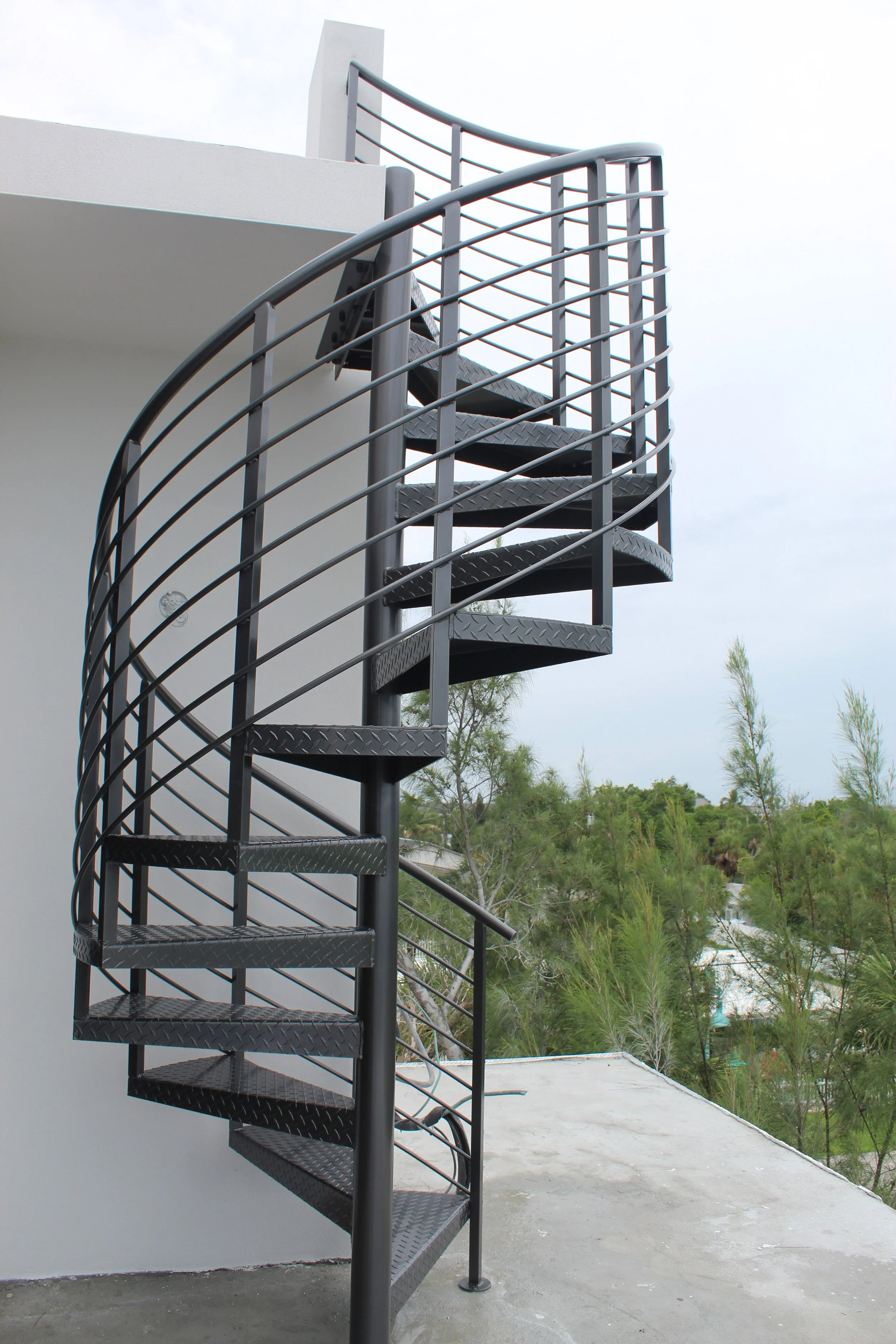 Custom aluminum spiral staircase for rooftop access in Englewood Florida by APG Welding