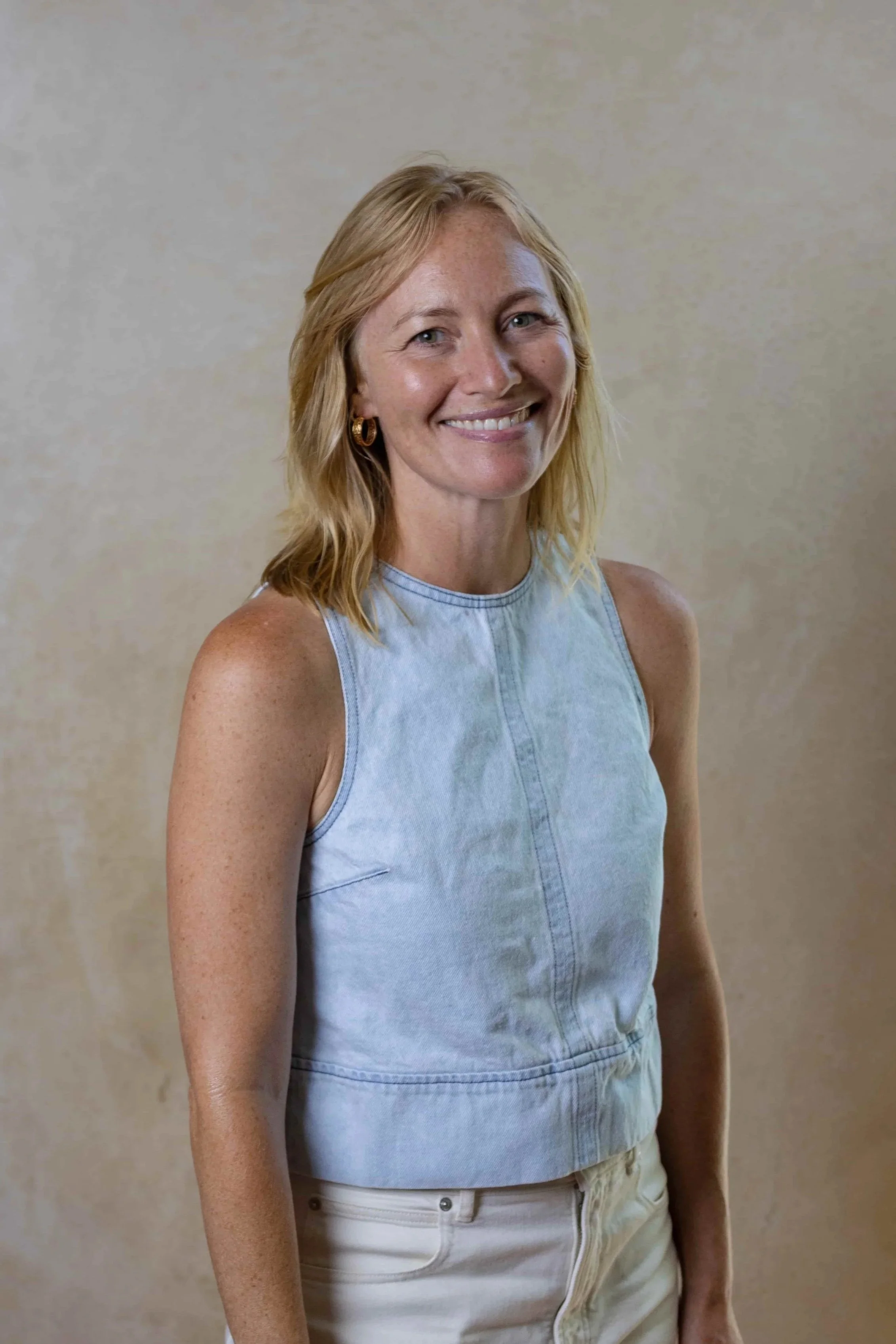 Woman in blue shirt and white pants