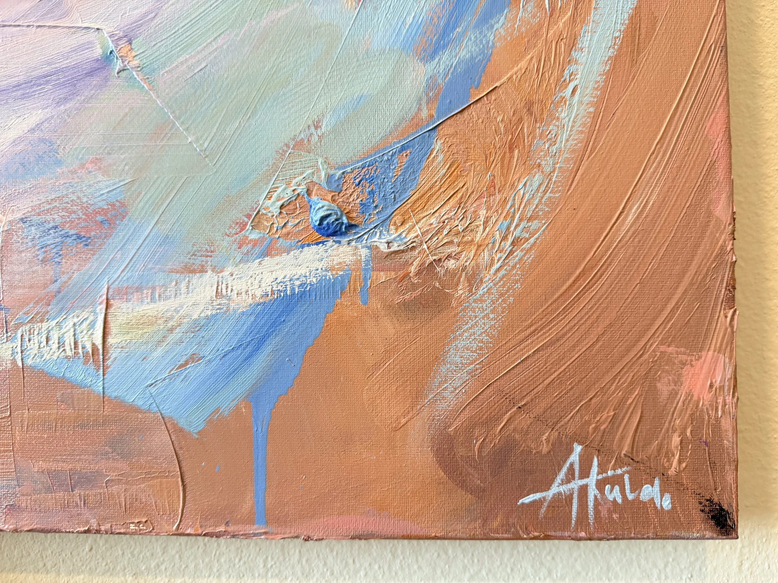 Close-up of an abstract textured painting with layered pastel blue, peach, lavender, and white brushstrokes on canvas.