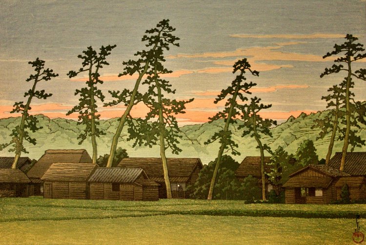 Tall, irregular pines rise above wooden village roofs and green fields beneath a muted peach evening sky.