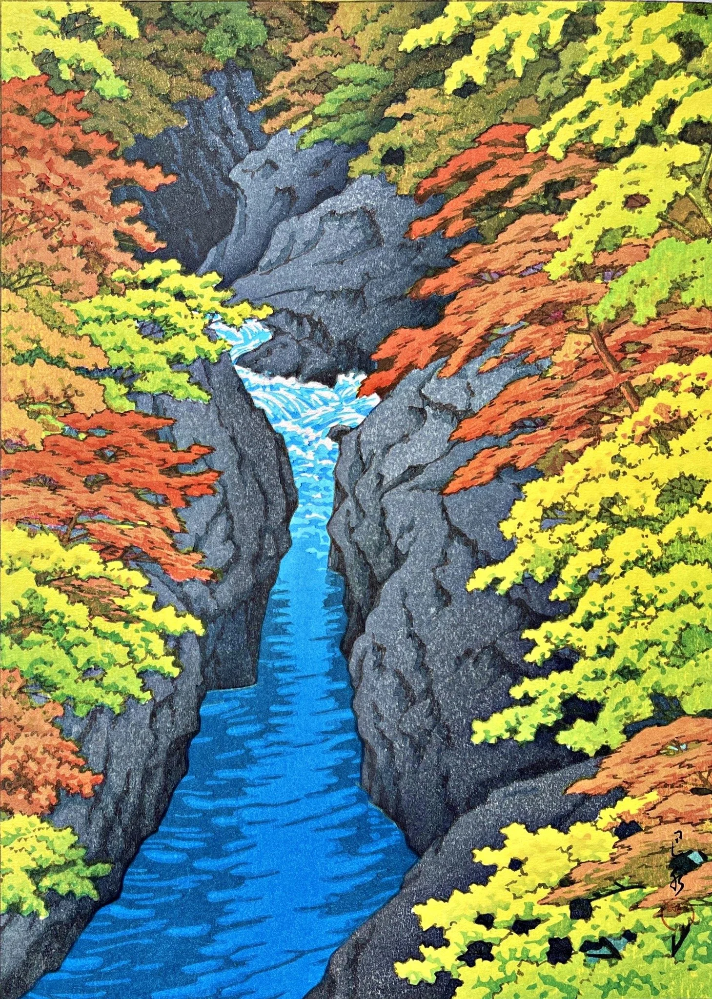 Azuma Gorge by Kawase Hasui: a vivid blue river and white rapids between tall grey cliffs, surrounded by autumn foliage in red, orange, yellow and green.