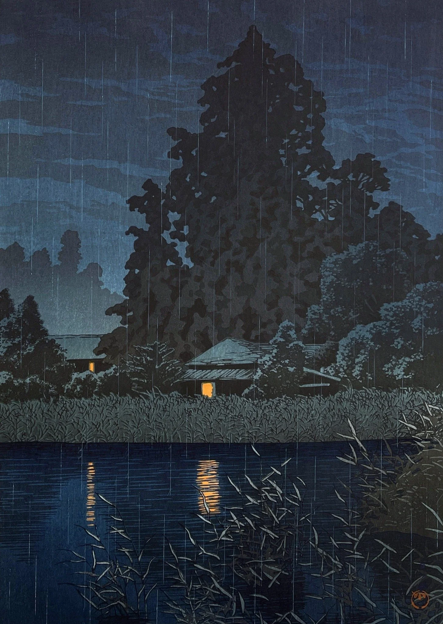 Rain at Ōmiya by Kawase Hasui: rain falls over dark trees, glowing windows and their golden reflections across blue water.