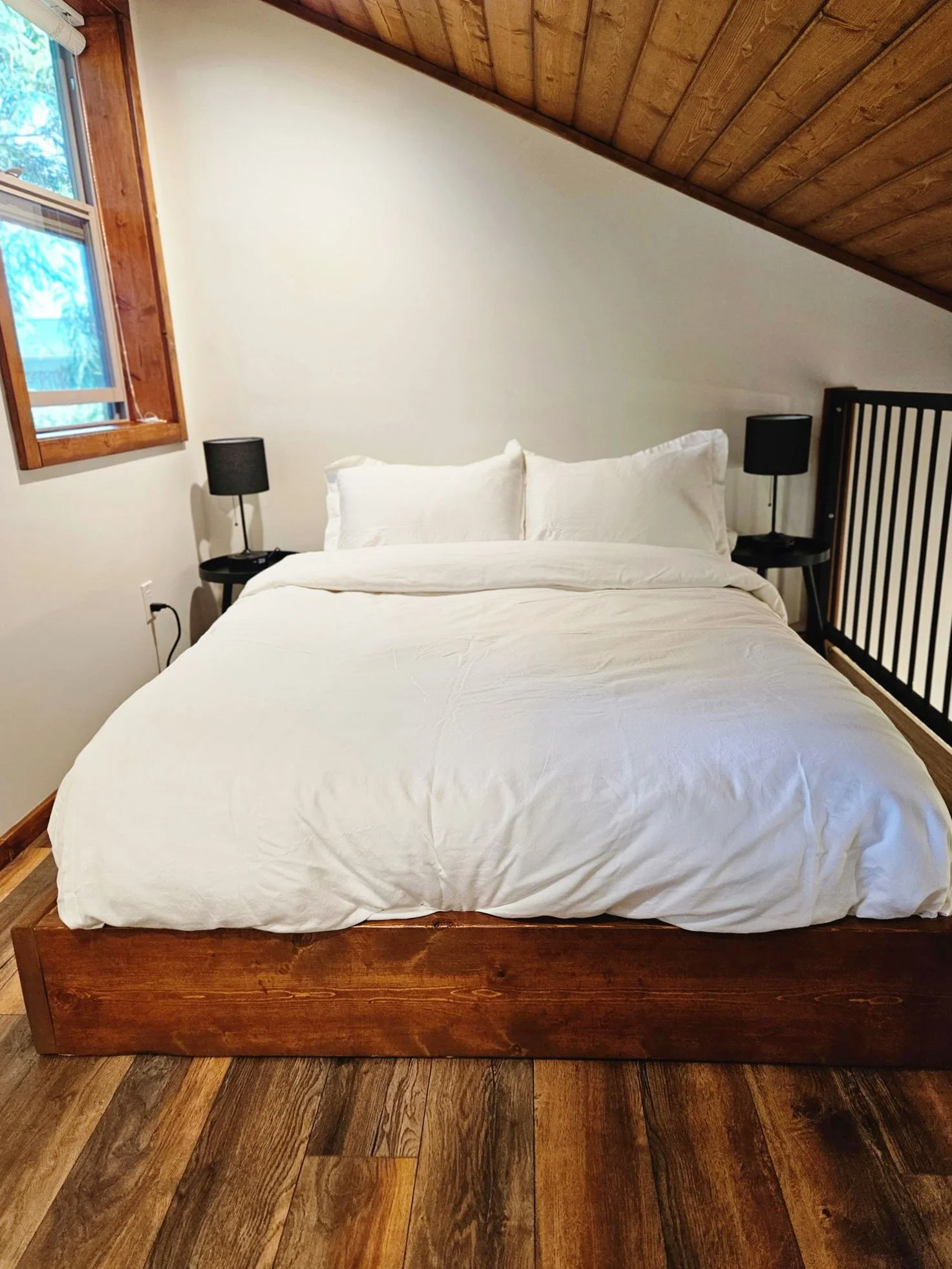 wood bed white linen cabin