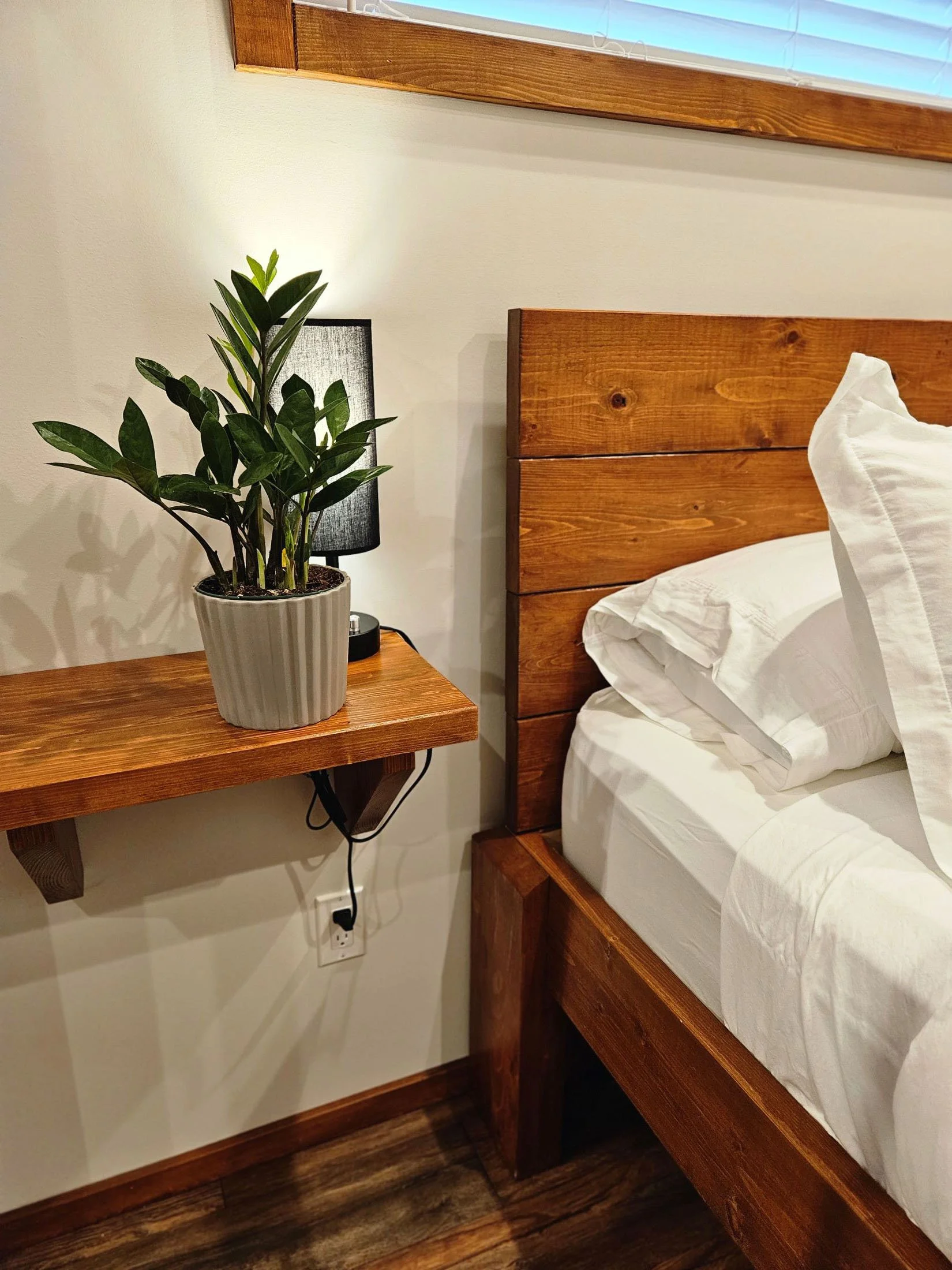 Wood bed with white sheets