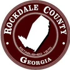 Seal of Rockdale County, Georgia, with the county's shape and name, established in 1870, on a maroon background.
