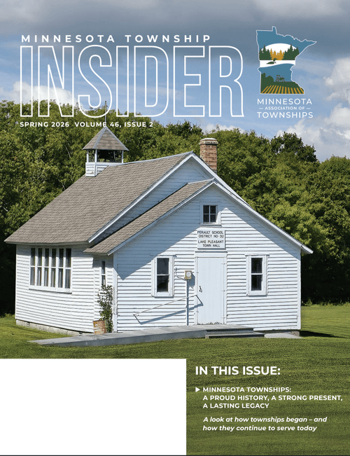 Cover of Minnesota Township Insider magazine showing a white historic schoolhouse with a bell tower and a sign for Perault School District 310, situated in a grassy area with trees in the background.