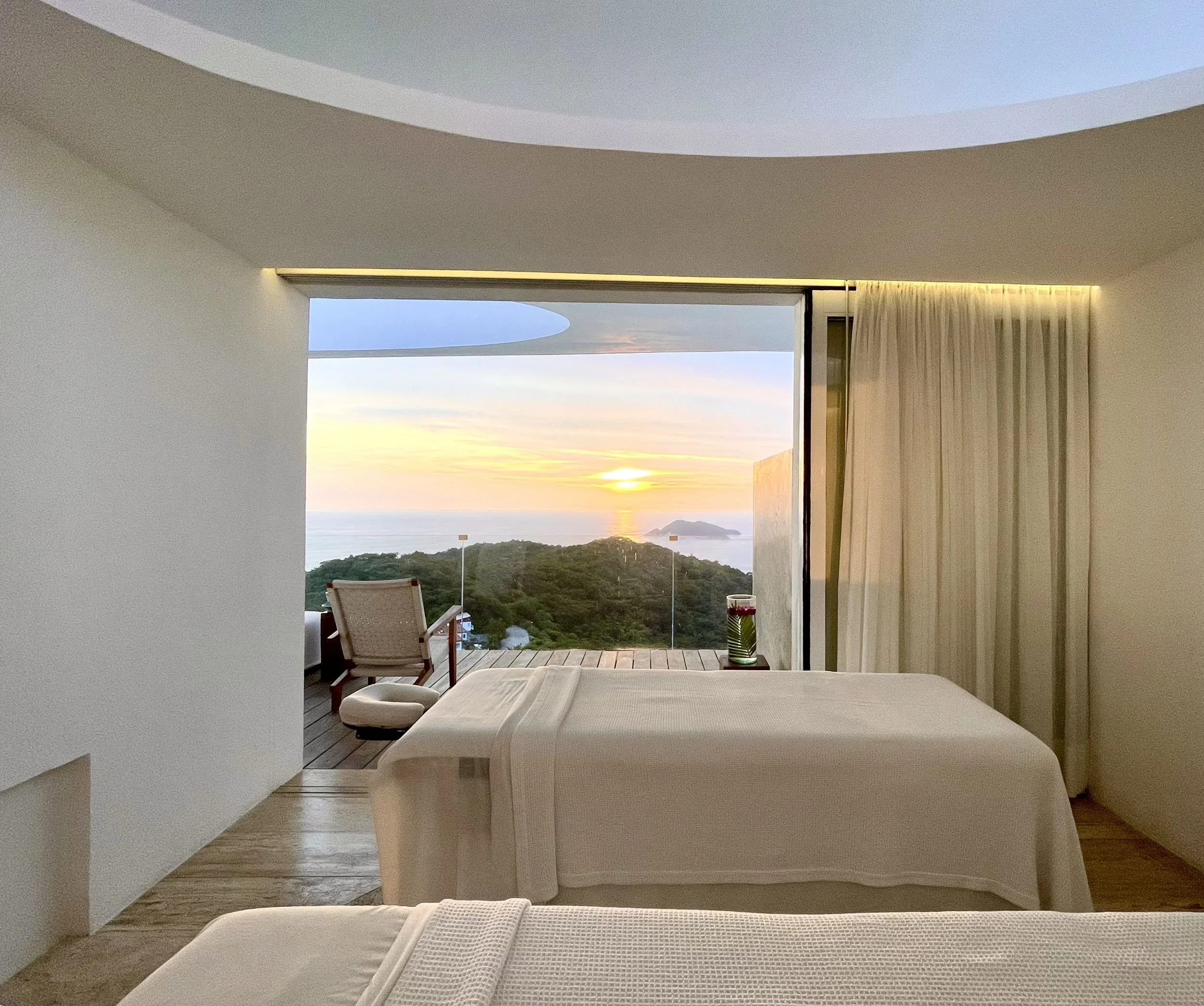 Cabina de masajes con ventanal de piso a techo abierto al horizonte y la luz de Brisas Marqués por Aragonés.