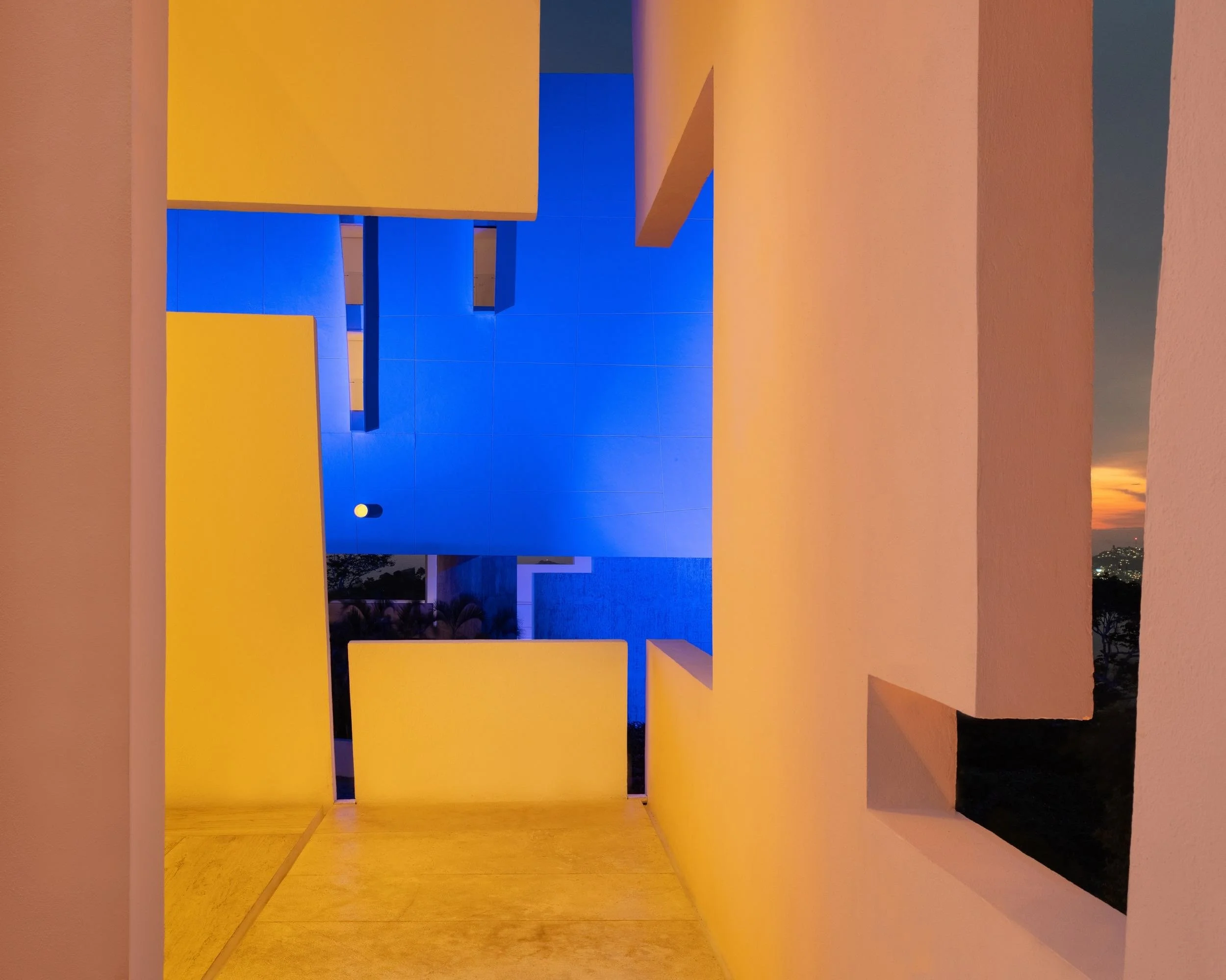 Juego geométrico de luces y sombras nocturnas en la arquitectura de autor de Encanto Acapulco.