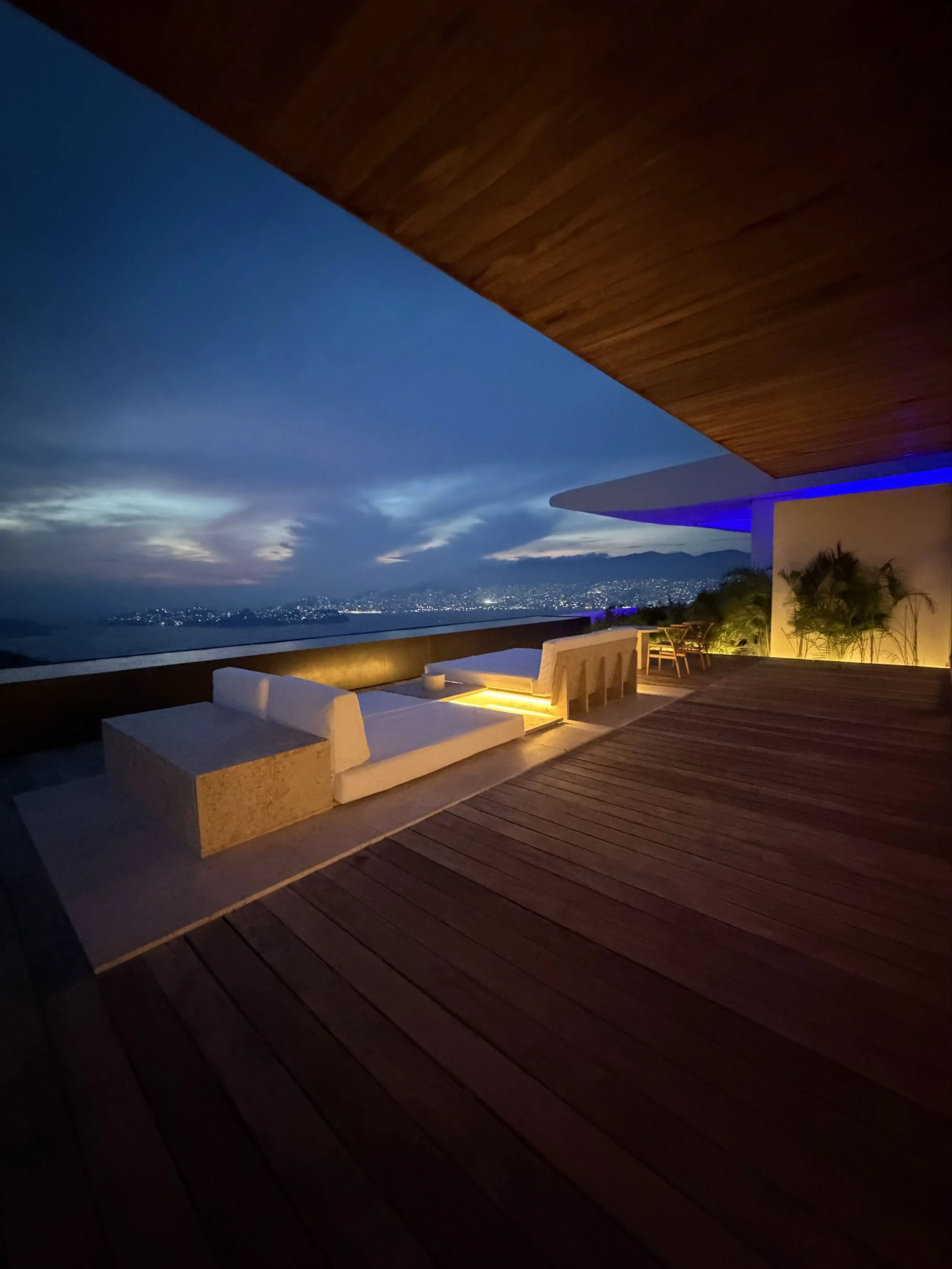 Terraza con vista nocturna en Signature Suite de Hotel Encanto. Espacio exterior iluminado con tonos cálidos y azules. 