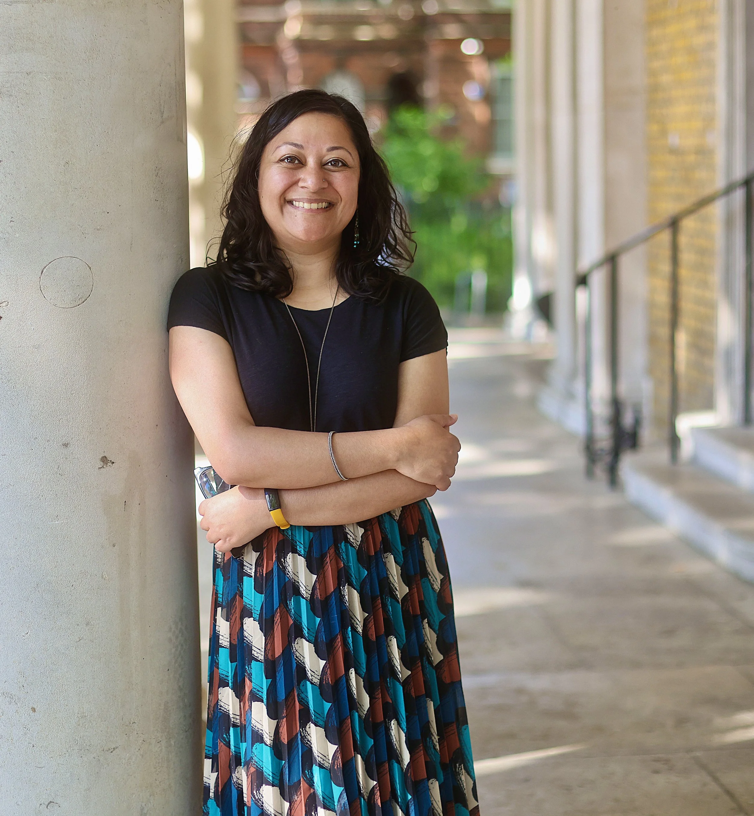 Nilima Choudhury, Person-Centred Psychotherapist based in Clapham, South London, smiling outdoors