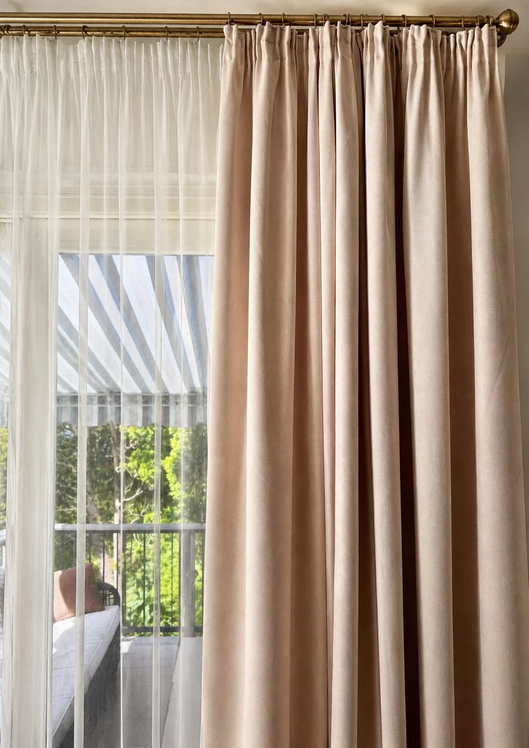 Tailored pleated custom drapery paired with sheer curtains for elegant everyday living.