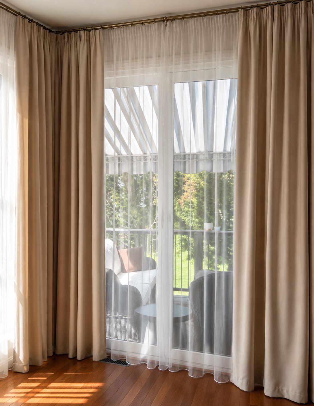 Custom full-length drapery and sheer curtains framing patio doors in a contemporary family home.